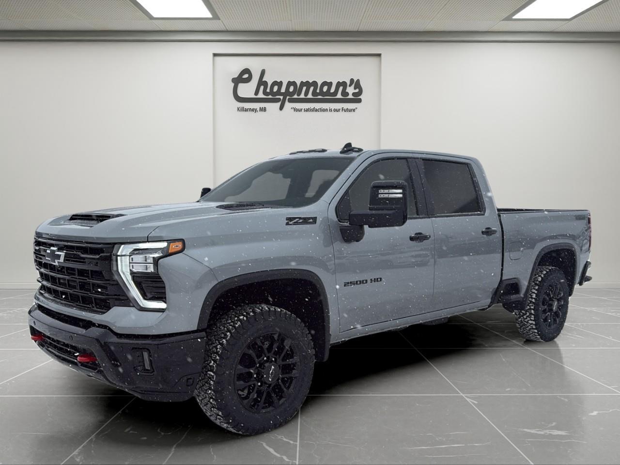 <p>The <strong>2026 Chevrolet Silverado 2500HD LT Crew Cab 4WD</strong> is built to handle demanding jobs while delivering modern technology and everyday comfort. Finished in <strong>Sterling Grey Metallic</strong> with a durable <strong>Jet Black interior</strong>, this heavy-duty pickup is exceptionally well equipped with the legendary <strong>Duramax 6.6L Turbo-Diesel V8</strong>, advanced trailering technology, and bold <strong>Trail Boss Package</strong> styling.</p><p>Paired with a <strong>10-speed automatic transmission</strong>, this Silverado offers massive torque, confident towing performance, and smooth power delivery, making it an excellent choice for hauling, trailering, or long highway drives.</p><h2><strong>Performance & Heavy-Duty Capability</strong></h2><ul><li><p><strong>Duramax 6.6L Turbo-Diesel V8 Engine</strong></p></li><li><p><strong>10-Speed Automatic Transmission</strong></p></li><li><p><strong>4WD with 2-Speed Electronic Transfer Case</strong></p></li><li><p><strong>Automatic Locking Rear Differential</strong></p></li><li><p><strong>Z71 Off-Road Package</strong></p><ul><li><p>Off-Road Suspension with Twin-Tube Shocks</p></li><li><p>Hill Descent Control</p></li><li><p>Skid Plates</p></li></ul></li><li><p><strong>Trailering Package with Hitch Guidance</strong></p></li><li><p><strong>Trailer Brake Controller</strong></p></li><li><p><strong>External Engine Oil Cooler & Auxiliary Transmission Cooler</strong></p></li><li><p><strong>Gooseneck / 5th Wheel Prep Package</strong></p></li><li><p><strong>High Idle Switch</strong></p></li><li><p><strong>Engine Block Heater</strong></p></li></ul><h2><strong>Trail Boss Package Highlights</strong></h2><p>Aggressive styling and off-road attitude:</p><ul><li><p><strong>20" High-Gloss Black Wheels</strong></p></li><li><p><strong>BFGoodrich Off-Road Tires</strong></p></li><li><p><strong>High-Gloss Black Front & Rear Bumpers</strong></p></li><li><p><strong>Black Bowtie & Black Badging</strong></p></li><li><p><strong>Red Tow Hooks</strong></p></li><li><p><strong>High-Intensity LED Headlamps</strong></p></li><li><p><strong>Black Skid Plate</strong></p></li><li><p><strong>Trailering Mirrors</strong></p></li></ul><h2><strong>Interior Comfort & Convenience</strong></h2><p>A functional cabin designed for long days behind the wheel:</p><ul><li><p><strong>Leather-Appointed Front Seats</strong></p></li><li><p><strong>Heated Front Seats</strong></p></li><li><p><strong>Heated Steering Wheel</strong></p></li><li><p><strong>10-Way Power Driver Seat</strong></p></li><li><p><strong>Dual-Zone Automatic Climate Control</strong></p></li><li><p><strong>Front 40/20/40 Bench Seat with Lockable Under-Seat Storage</strong></p></li><li><p><strong>Rear Sliding Power Window</strong></p></li><li><p><strong>Remote Vehicle Start</strong></p></li><li><p><strong>Universal Home Remote</strong></p></li><li><p><strong>120V Power Outlets (Cab & Bed)</strong></p></li></ul><h2><strong>Technology & Connectivity</strong></h2><p>Advanced tech keeps you informed and connected:</p><ul><li><p><strong>13.4" Chevrolet Infotainment 3 Premium Touchscreen</strong></p><ul><li><p>Google Built-In compatibility</p></li><li><p>Navigation capability</p></li><li><p>Bluetooth</p></li></ul></li><li><p><strong>Wireless Apple CarPlay & Android Auto</strong></p></li><li><p><strong>12.3" Reconfigurable Digital Driver Display</strong></p></li><li><p><strong>HD Surround Vision</strong></p></li><li><p><strong>Bed View Camera</strong></p></li><li><p><strong>Trailer Side Blind Zone Alert</strong></p></li><li><p><strong>Rear Cross Traffic Alert</strong></p></li><li><p><strong>Trailer Camera Provisions & Trailering App</strong></p></li><li><p><strong>Keyless Open & Start</strong></p></li><li><p><strong>OnStar Basics (up to 8 years)</strong></p></li><li><p><strong>SiriusXM with Trial</strong></p></li></ul><h2><strong>Safety & Driver Assistance</strong></h2><p>Includes <strong>Chevy Safety Assist</strong> and additional trailering-focused protection:</p><ul><li><p>Automatic Emergency Braking</p></li><li><p>Forward Collision Alert</p></li><li><p>Front Pedestrian Braking</p></li><li><p>Lane Departure Warning</p></li><li><p>Following Distance Indicator</p></li><li><p>IntelliBeam Auto High Beams</p></li><li><p>Front & Rear Park Assist</p></li><li><p>Rear Seat Reminder</p></li><li><p>Teen Driver Mode</p></li></ul><h2><strong>Exterior Features</strong></h2><ul><li><p><strong>CornerStep Rear Bumper & Integrated BedStep</strong></p></li><li><p><strong>Chevytec Spray-On Bedliner</strong></p></li><li><p><strong>LED Cargo Bed Lighting</strong></p></li><li><p><strong>Rear Wheelhouse Liners</strong></p></li><li><p><strong>Power Up/Down Tailgate</strong></p></li><li><p><strong>LED Roof Marker Lamps</strong></p></li></ul><h3><strong>Why Choose This Silverado 2500HD LT</strong></h3><p>With its <strong>Duramax diesel power</strong>, <strong>Trail Boss appearance</strong>, <strong>Z71 off-road capability</strong>, and <strong>industry-leading trailering technology</strong>, this <strong>2026 Silverado 2500HD LT 4WD</strong> is a serious truck for serious workwithout sacrificing comfort or modern tech.</p><p>2 Year/24,000 kilometer* Complimentary Oil Changes (2 total)</p><p>3 Year/60,000 kilometer* Base Warranty Coverage</p><p>5 Year/100,000 kilometer* Powertrain Component Warranty Coverage</p><p>5 Year/100,000 kilometer* Courtesy Transportation and 24/7 Roadside Assistance</p><p>6 Year/160,000 kilometer* Sheet Metal (Rust Through) Perforation Warranty Coverage</p><p>*Whichever Comes First.</p><p>Price Includes HD Flaps & 6 Tube Steps.</p><p>Price Includes Dealer Fee.</p><p>Price Excludes PST & GST.</p><p>Financing Options Available, Call For More Details.</p> <p><strong>*While every reasonable effort is made to ensure the accuracy of this information, we are not responsible for any error or omissions contained on these pages. Please verify any information in question with Chapman Motors Ltd.</strong></p>