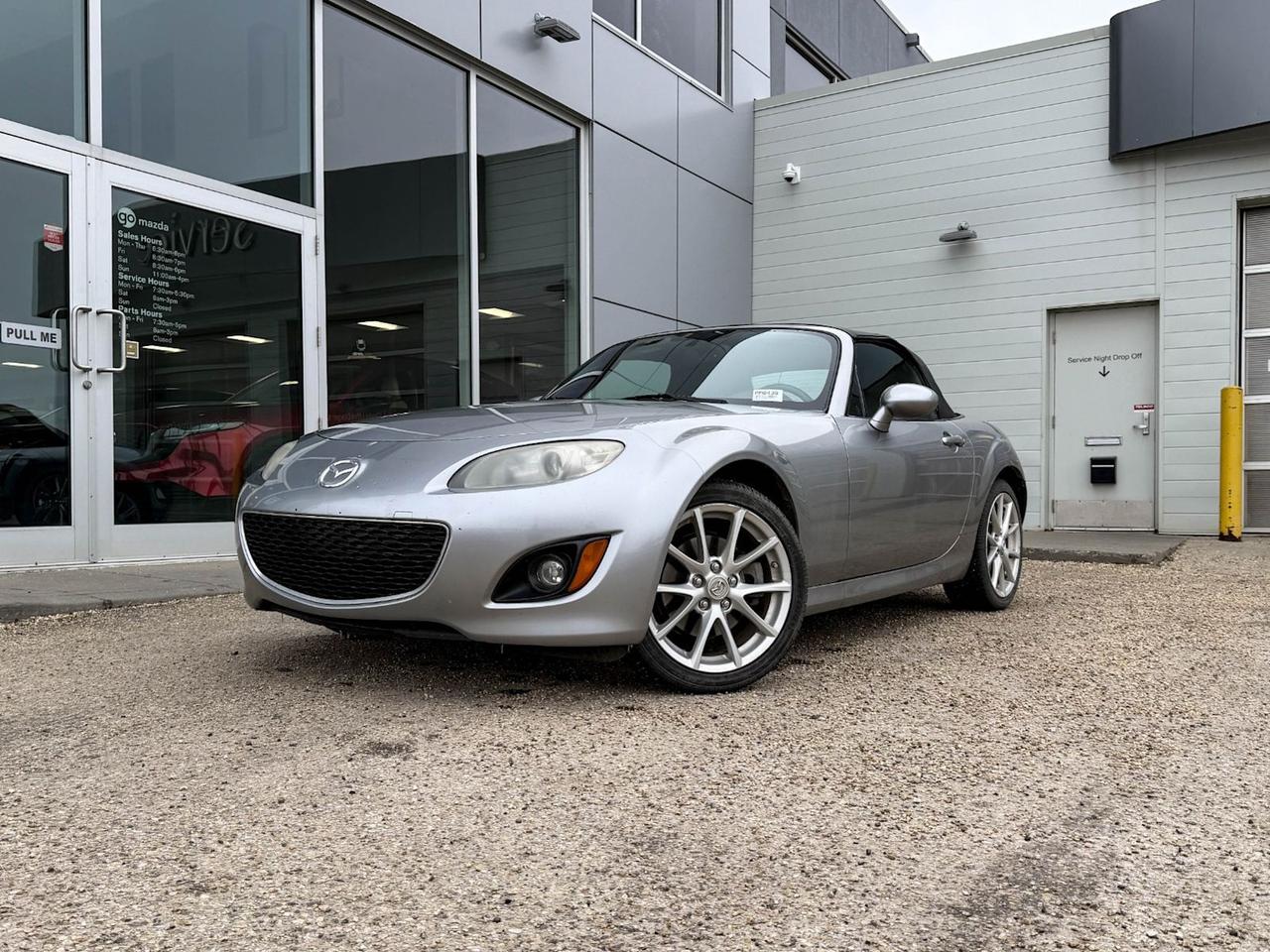 Experience pure driving joy with this pre-owned 2011 Mazda MX-5 Miata Touring 2dr Convertible! Sporting a sleek black exterior and comfortable black cloth interior, this iconic roadster features a spirited 2.0L DOHC I4 engine paired with a responsive 6-speed sport automatic transmission for smooth, rear-wheel-drive thrills. Enjoy the freedom of a manual convertible soft top, premium summer performance tires on 17 alloy wheels, and sporty handling thanks to its independent suspension and lightweight aluminum engine components.Inside, youll find reclining bucket seats, cruise control, a 6-disc CD changer, and steering wheel audio controls, all designed for an engaging yet comfortable drive. Safety comes standard with front and side airbags, ABS brakes, and stability features. This MX-5 combines classic roadster fun with reliable Mazda engineeringperfect for those who crave spirited drives and top-down adventures. Dont miss your chance to own this legendary sports car! Contact us today to schedule your test drive.Go Mazda is an AMVIC licensed businessThis vehicle has been registered in the following locations in theUnited States in the state ofTexas andArizona