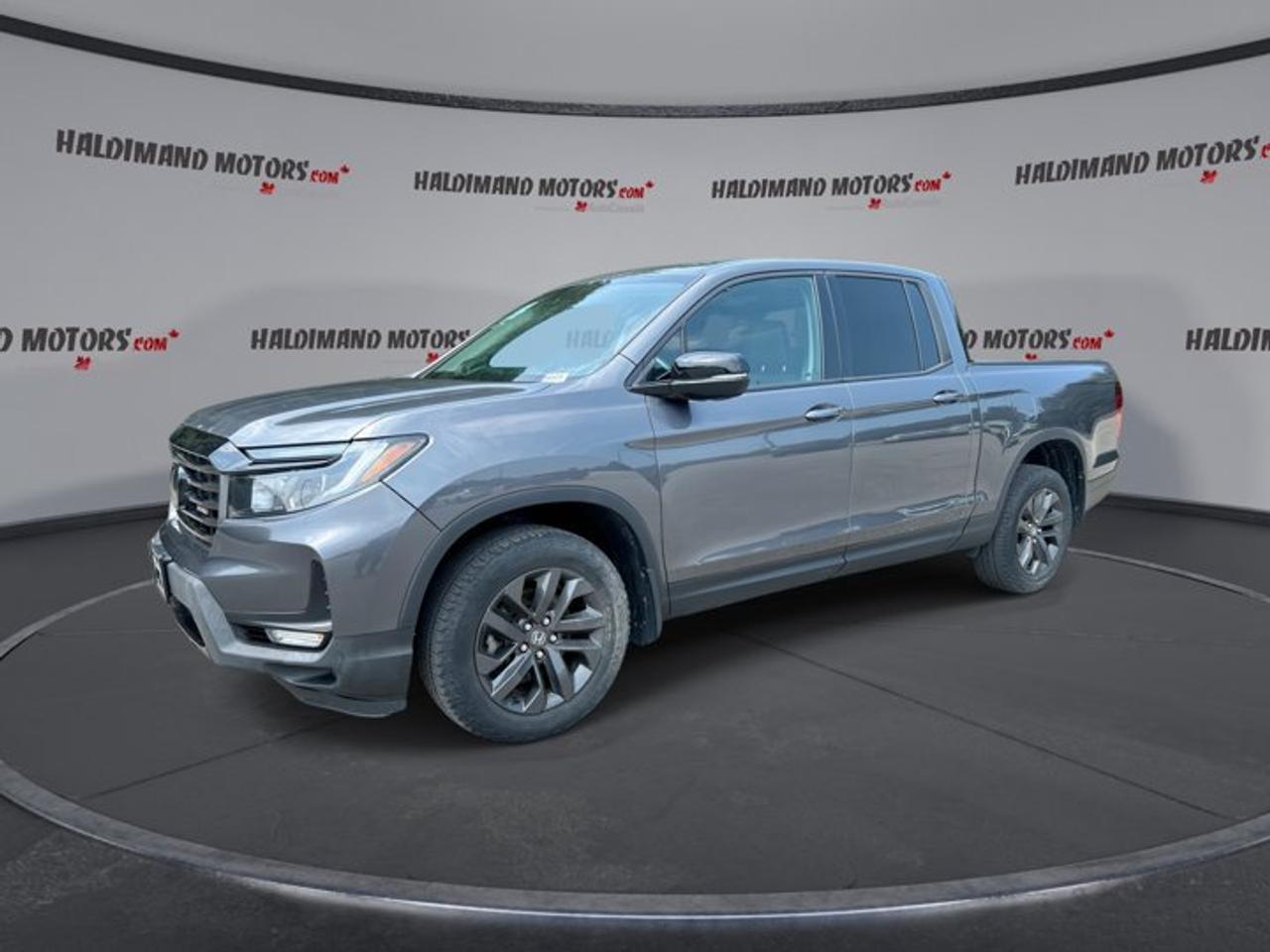 // SINGLE OWNER! //<br /><br />This 2023 Honda Ridgeline Sport Crew Cab 5 Bed AWD | One Owner | Heated Steering Wheel is a smart pick for drivers who want truck strength with everyday comfort. Sold by Haldimand Motors Ltd. in Cayuga, this used Honda comes finished in Grey with a Black interior, four doors, and just 22,546 km.<br /><br />Powered by a 3.5-litre gas engine and paired with an automatic transmission, this 2023 Honda Ridgeline Sport Crew Cab 5 Bed AWD | One Owner | Heated Steering Wheel delivers smooth power for commuting, travel, and weekend hauling. All-wheel drive adds confidence in changing Ontario weather, while the heated steering wheel brings welcome comfort on cold mornings.<br /><br />FEATURES OF THE Ridgeline Sport Crew Cab 5 Bed AWD | One Owner | Heated Steering Wheel<br />   Single-owner truck with low kilometres<br />   Heated steering wheel for winter comfort<br />   Sunroof adds light and fresh air<br />   All-wheel drive for year-round confidence<br /><br />TRUCK FEATURES<br />   Tows up to 2,267 kilograms confidently<br />   Trailer hitch ready for towing tasks<br />   Crew cab adds passenger-friendly space<br />   Rear trunk access boosts utility<br /><br />ADVANCED SAFETY FEATURES<br />   Backup camera helps with reversing<br />   Blind spot monitor adds lane awareness<br />   Lane departure warning supports safer travel<br />   Adaptive cruise control eases highway driving<br /><br />PERFORMANCE AND EFFICIENCY<br />   3.5-litre gas engine delivers strong power<br />   Automatic transmission shifts smoothly every day<br />   Limited slip differential aids traction<br />   All-wheel drive supports steady handling<br /><br />COMFORT AND CONVENIENCE<br />   Heated front seats for cold days<br />   Heated steering wheel feels great quickly<br />   Dual-zone climate control improves comfort<br />   Remote starter adds everyday convenience<br /><br />TECHNONOLGY AND CONNECTIVITY<br />   Apple CarPlay keeps apps within reach<br />   Android Auto connects your smartphone easily<br />   Bluetooth integration supports hands-free calling<br />   Steering wheel audio controls simplify use<br /><br />CARGO SPACE<br />   Rear trunk access adds hidden storage<br />   Four-door cab helps load passengers easily<br />   Spacious cabin supports daily versatility<br />   Truck bed handles gear and supplies<br /><br />AWARDS & RECOGNITIONS<br />   Top Safety Pick, Insurance Institute for Highway Safety, 2023<br /><br />WHAT OTHER OWNERS LIKE<br />   Smooth ride for a pickup truck<br />   Clever storage for daily practicality<br />   Strong V6 power for confident driving<br />   Comfortable cabin for family use<br /><br />This Honda Ridgeline stands out by blending pickup capability with the easy road manners many drivers want every day. The ride stays composed, the cabin feels practical, and the controls are simple to use. Features like power steering, cruise control, push button start, and automatic headlights make each trip easier.<br /><br />Inside, this truck is well equipped for comfort and convenience. You get front air conditioning, rear air conditioning, rear climate control, power windows, heated mirrors, electric mirrors, tinted windows, and a drivers seat with lumbar support. The drivers side power seat and electric passenger seat help both front occupants find a comfortable position.<br /><br />This Ridgeline also adds useful details that improve daily ownership. Fog lights help in poor weather, LED headlamps offer crisp visibility, and the rear window defroster supports clear sightlines in winter. Tire pressure monitoring helps you stay informed, while child safety locks and multiple airbags add peace of mind for family travel.<br /><br />With its practical four-door layout, strong towing ability, and well-rounded list of features, this Honda is ready for work, errands, and road trips alike. It offers the versatility of a truck without giving up comfort, technology, or everyday drivability. For drivers in Cayuga looking for a dependable and refined used pickup, this Ridgeline is an excellent fit.<br /><br />This 2023 Honda Ridgeline Sport Crew Cab 5 Bed AWD | One Owner | Heated Steering Wheels VIN is: 5FPYK3F19PB502295.<br /><br />WHY CHOOSE US? <br /><br />Honest & Transparent Buying Experience: Weve been a trusted name in business since 1984.<br /><br />STRAIGHTFORWARD PRICING:<br />Our Advertised Price Includes:<br />>>Safety Certification (No separate fee!)<br />>>30-Day 100% Mechanical Warranty<br />>>FREE Carfax History Report.<br />>>No upcharge for paying cash.<br />(Prices Exclude HST and Licensing Fees only.)<br /><br />>>Browse 300+ vehicles all in ONE LOCATION<br /><br />EASY FINANCING: Great rates & open loans<br /><br />WE BUY CARS: Get Top Dollar for your trade-in, or sell us your vehicle for CASH! Even if you dont buy from us!<br /><br />STOP BY TODAY<br />Treat yourself - stop by Haldimand Motors Ltd. located at 42 Talbot St E, Cayuga, ON N0A 1E0 to make this car yours today!<br /><br />https://www.haldimandmotors.com/used/stock-460470.html