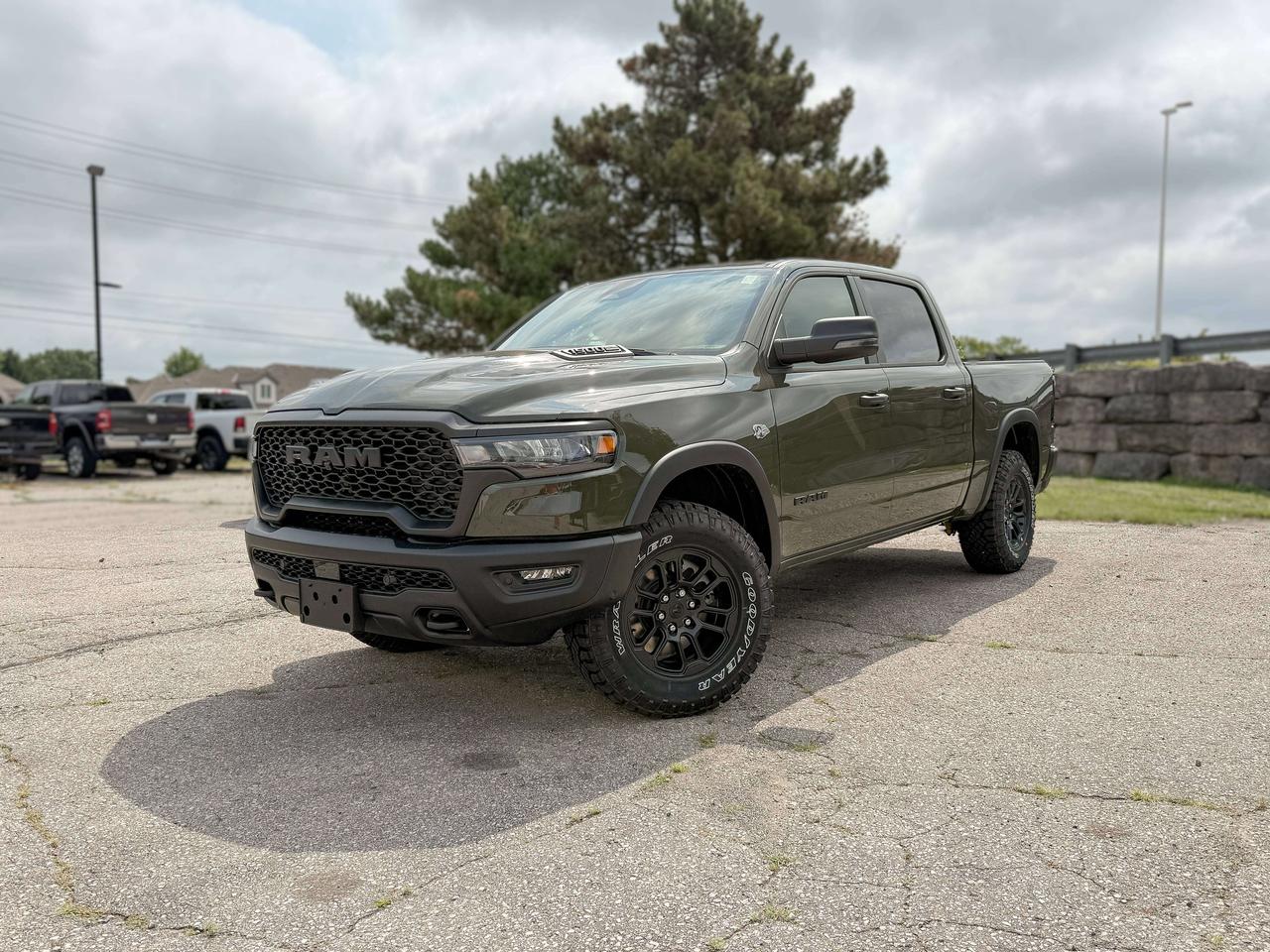Bold and unmistakable, our New 2026 RAM 1500 Rebel Crew Cab 4X4 in Tank Green stands out with aggressive design and off-road capability. Powered by a 5.7 Litre HEMI eTorque V8 and a 48V Mild-Hybrid system offering 395hp paired with an 8 Speed Automatic transmission engineered for off-road domination. A raised ride height, performance shocks, and a shift-on-demand transfer case can take this Four Wheel Drive truck further down the trail, and it achieves approximately 9.8L/100km on the highway. Our fierce and stylish RAM features LED lighting, fog lamps, a sport performance hood, bold graphics, black alloy wheels, a hitch receiver, off-road fender flares, and robust skid plates. Our Rebel cabin is ready for rough terrain thanks to its heated cloth front seats, eight-way power for the driver, a heated-wrapped steering wheel, dual-zone automatic climate control, 12V/115V outlets, a power rear window, and remote start. Off-Road Info Pages enhance the infotainment system, which bundles a 12-inch driver display, 12-inch touchscreen, full-color navigation, WiFi compatibility, Android Auto&reg;/Apple CarPlay&reg;, Bluetooth&reg;, voice control, and nine-speaker audio. For safetys sake, RAM supplies front/rear auto braking, blind-spot monitoring, adaptive cruise control, active lane management, trailer sway damping, hill-start assistance, and more. Committed to truck leadership, our 1500 Rebel is a compelling choice! Save this Page and Call for Availability. We Know You Will Enjoy Your Test Drive Towards Ownership!
