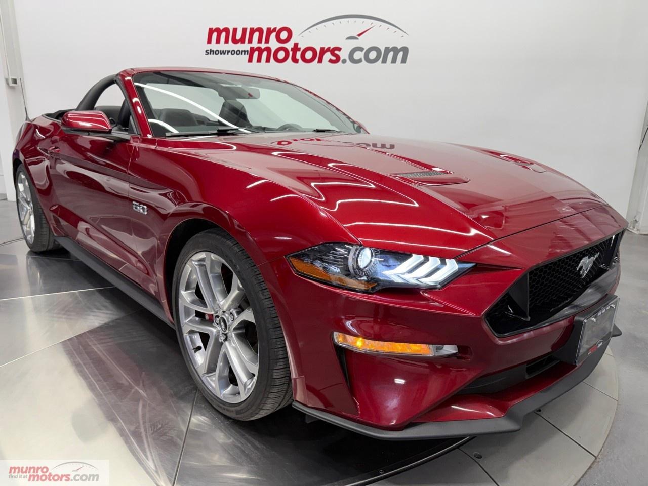 Vehicle Highlights include: GT Performance Package, Premium Package, Black Power Convertible Soft Top, 20 Inch Wheels, Red Brembo Brake Calipers, Classic Design Light Bar, Low Profile Spoiler, Leather Seats, Heated & Cooled Seats, NAV Navigation, Bluetooth, CD Changer, Apple Carplay, Ambient Lighting, Cold Air Intake, WeatherTech Floor Liners & Trunk, <br /><br /> The 2018 Ford Mustang GT Premium Convertible represents a significant evolution of the Mustang formula, blending classic V8 muscle with modern technology, improved refinement, and the added thrill of open-top driving. With updated styling, enhanced performance, and a more sophisticated interior, the 2018 model stands out as one of the most well-rounded Mustangs of its generation. <br /><br /> At the heart of the Mustang GT is a 5.0L Coyote V8 engine, delivering 460 horsepower and 420 lb-ft of torque. This high-revving V8 provides strong, linear acceleration and a signature exhaust note that captures the essence of American muscle. For 2018, the engine received updates that improved both power and responsiveness, making it more eager across the rev range. A 10-speed automatic offers quick, efficient shifts and impressive performance. <br /><br /> The Ruby Red Tintcoat exterior is deep, lustrous, and full of character. In direct sunlight, it reveals a vibrant red tone layered with metallic flake, giving the paint a glowing, almost liquid appearance that highlights the Mustangs sculpted hood and sharp body lines. As the lighting softens, the color darkens into a more subdued, wine-like shade, adding a sense of maturity and refinement. The tintcoat finish adds depth and movement, making the car visually dynamic from every angle. <br /><br /> Inside, the ebony interior provides a strong and cohesive contrast. The black leather surfaces create a focused, performance-oriented cabin that complements the Mustangs muscular nature. <br /><br /> The convertible design adds an extra dimension to the Mustang experience. The power-operated soft top can be lowered quickly, transforming the car into an open-air cruiser that enhances the sound of the V8 and the connection to the road. With the top up, the cabin remains quiet and comfortable, making it suitable for daily driving as well as longer trips. <br /><br /> Visually, the 2018 Mustang features a refreshed design with a more aggressive front end, sleeker headlights, and a lower, wider stance. The GT trim adds performance-oriented details such as unique badging, larger wheels, and dual exhaust outlets, reinforcing its sporty identity while maintaining the Mustangs iconic silhouette. <br /><br /> Inside, the Premium trim elevates the cabin with higher-quality materials and advanced technology. Leather seating, and an upgraded infotainment system create a more modern and comfortable environment. The layout remains driver-focused, with controls positioned for ease of use, while features like heated and ventilated seats add everyday convenience. <br /><br /> On the road, the 2018 Mustang GT Premium Convertible offers a balanced driving experience that combines power and comfort. The V8 delivers strong acceleration, while improvements to the suspension and chassis provide better handling and stability compared to earlier models. Steering is more precise, and the car feels more composed through corners, making it enjoyable not only in straight-line performance but also on winding roads. <br /><br /> Despite its performance capabilities, the Mustang remains practical enough for regular use. The rear seats, while compact, add a level of versatility, and the trunk offers reasonable space for a convertible. The combination of comfort features and performance makes it a car that can be enjoyed in a variety of situations. <br /><br /> Ultimately, the 2018 Ford Mustang GT Premium Convertible captures the spirit of modern muscle. It delivers powerful V8 performance, updated technology, and the freedom of open-air driving in a package that remains true to its heritage while embracing contemporary refinement. For those seeking a convertible that offers both excitement and everyday usability, it stands as a compelling and iconic choice. <br /><br /> The GT Premium Convertible has a Clean Carfax with low kms. Come on down to Munro Motors & see this one for yourself, it is in stock. We will look forward to seeing you real soon!<br /><br /> <p>Carfax: <a target=_blank rel=noopener noreferrer nofollow href=https://vhr.carfax.ca/en/?id=AdF6OxjZcFZeo2db2RmGyy3fCnC50bH8>https://vhr.carfax.ca/en/?id=AdF6OxjZcFZeo2db2RmGyy3fCnC50bH8</a></p><p></p><p>Check us out on youtube: click here</p><p>Like us on Facebook: <a target=_blank rel=noopener noreferrer nofollow href=https://www.facebook.com/munromotors/>https://www.facebook.com/munromotors/</a></p><p>We are located in Brantford, Ontario; Telephone City and the hometown of hockey legend Wayne Gretzky. Formerly located in St. George, Ontario for ten years, we are still east of London, south of Cambridge, and west of Hamilton. In order to get our customers to come here, we have to have great prices and then when you get here, we have to have a great car in order to earn your business.</p><p>Our business hours are Monday to Friday 10am to 5pm. We are closed on Saturdays and Sundays.</p><p>At Munro Motors, we find unique vehicles and post our entire stock online in order to ensure that our vehicles find their happy home.</p><p>To ensure our customers can get what they've always wanted, we offer financing services through TD Auto Finance, Desjardins, CIBC Auto Finance and Independent Leasing Companies on vehicles that are less than ten model years old and boats that are less than twenty-five model years old.</p><p>We also offer warranty products through Lubrico and GVC warranties to ensure that your mechanical baby stays in tip-top condition.</p><p>All of our vehicles are hand-picked by the very knowledgeable owner, Andy Munro, who has been connecting people to their dreams for many years.</p><p><a target=_blank rel=noopener noreferrer nofollow href=http://Munromotors.com>Munromotors.com</a></p><p>Email: <a target=_blank rel=noopener noreferrer nofollow><u>sales@munromotors.com</u></a></p><p>Most of our vehicles are already reconditioned, saftied, etested and ready to drive home with you.</p><p>Delivery is available. Ask for details</p><p>All prices are subject to HST and licensing, no hidden fees.</p>