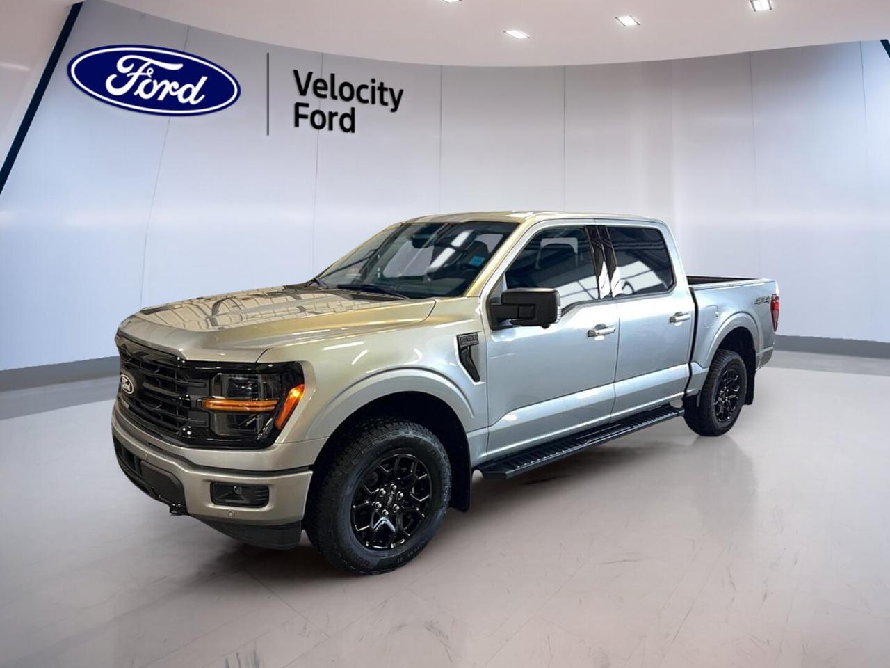 Meet the brand new 2026 Ford F-150 XLT 4WD SuperCrew 5.5 Box at Velocity Ford in Moose Jaw. Finished in Silver with a Black interior, this full-size pickup blends everyday ease with proven truck strength. Its four-door SuperCrew cabin, automatic transmission, and 2.7-litre unleaded engine make it ready for work and family use.

Built for Canadian roads and changing weather, the 2026 Ford F-150 XLT 4WD SuperCrew 5.5 Box gives you confident four-wheel drive, a practical 5.5-foot box, and a strong towing capacity of 4,671 kg. It also adds useful driver-assist features and modern connectivity, giving you solid value in a brand new truck.

FEATURES OF THE F-150 XLT 4WD SuperCrew 5.5 Box
»» SuperCrew cabin adds roomy rear seating
»» 5.5-foot box supports daily cargo duties
»» Four-wheel drive boosts all-season traction
»» XLT trim balances value and utility

TRUCK FEATURES
»» Tows up to 4,671 kg confidently
»» Rear tow hook supports recovery needs
»» Off-road tires add extra traction
»» Spare tire helps on remote trips

ADVANCED SAFETY FEATURES
»» Backup camera helps with reversing visibility
»» Blind spot monitor adds lane awareness
»» Lane departure warning supports safer travel
»» Side and head airbags enhance protection

PERFORMANCE AND EFFICIENCY
»» 2.7-litre unleaded engine delivers strong response
»» Automatic transmission supports smooth daily driving
»» Dual shift mode adds driver control
»» Four-wheel drive improves grip on roads

COMFORT AND CONVENIENCE
»» Cruise control helps on highway drives
»» Front air conditioning keeps cabin comfortable
»» Power windows add everyday convenience
»» Driver lumbar support aids long trips

TECHNONOLGY AND CONNECTIVITY
»» Bluetooth integration supports hands-free calling
»» WiFi hotspot keeps devices connected
»» Satellite radio expands entertainment choices
»» Steering wheel audio controls simplify access

CARGO SPACE
»» Rear trunk access improves loading convenience
»» SuperCrew cabin offers useful interior storage
»» Four doors help passenger and gear access
»» Box handles tools and weekend supplies

WHAT OTHER OWNERS LIKE
»» Strong towing ability for daily tasks
»» Spacious cabin for family and crew
»» User-friendly tech feels easy to use
»» Confident four-wheel drive in poor weather

This brand new 2026 Ford F-150 XLT 4WD SuperCrew 5.5 Box is a smart choice for drivers who need real pickup capability without giving up comfort. The Silver exterior gives it a clean, modern look, while heated power mirrors, automatic headlights, fog lights, tinted windows, and LED headlamps add daily confidence and convenience.

Inside, this truck is set up for practical use. You get power steering, an adjustable steering wheel, illuminated vanity mirrors for driver and passenger, rear window defroster, automatic door locks, and child safety locks. These details help make every drive easier, whether you are heading across town or out on the highway.

Safety is a major strength here. Anti-Lock Braking System, stability control, tire pressure monitoring, driver and passenger airbags, passenger airbag sensor, and side impact protection all work together to support peace of mind. For busy parking lots and changing traffic, the backup camera and blind spot monitor are especially useful.

If you want a new truck that feels capable, connected, and ready for real work, this 2026 Ford F-150 XLT 4WD SuperCrew 5.5 Box deserves a close look at Velocity Ford in Moose Jaw. It delivers the versatility many Canadian drivers want, with practical features that fit both weekday jobs and weekend plans.

This 2026 Ford F-150 XLT 4WD SuperCrew 5.5 Boxs VIN is: 1FTEW3LP5TKD40977.