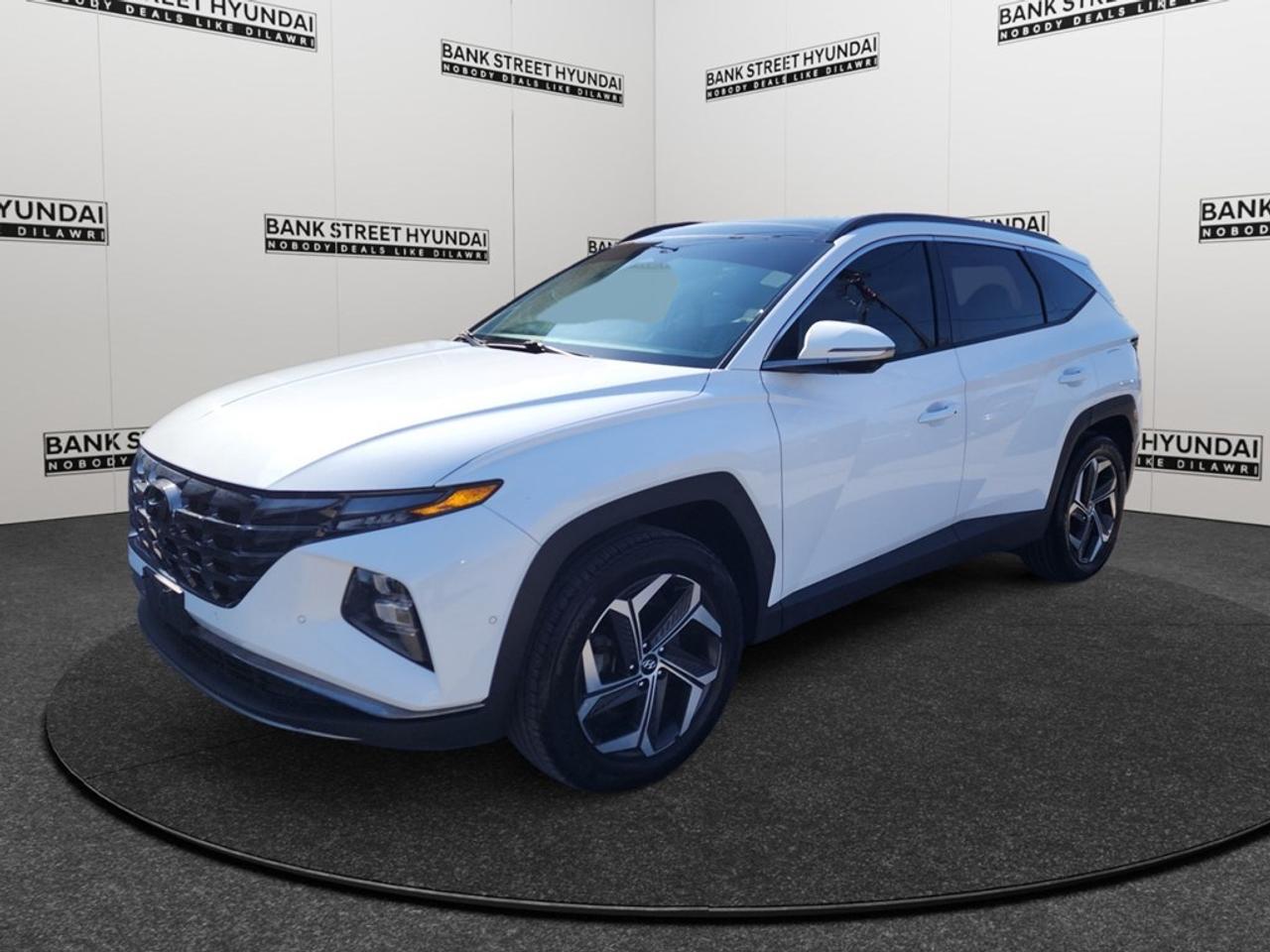 Introducing the 2023 Hyundai Tucson Hybrid Ultimate AWD in stunning white, perfect for navigating the Canadian terrains with its all-wheel-drive capability. This SUV offers an impeccable balance of power and smooth handling, thanks to its automatic transmission and precision-engineered chassis. The Tucson Hybrid Ultimate boasts a sophisticated exterior that draws attention with its sleek lines and premium alloy wheels. Step inside to experience a haven of luxury with leather seats, a leather steering wheel, and a panoramic sunroof that adds a touch of elegance. The automatic parking and parking sensors make city driving a breeze, while heated and cooled seats ensure comfort in any weather. With cutting-edge technology at your fingertips, this vehicle features a high-resolution navigation system, a smart device integration interface, and a satellite radio for endless entertainment. Safety is paramount with advanced driver assistance technologies such as lane assist and adaptive cruise control, supported by a comprehensive backup camera. If youre seeking a versatile yet luxurious vehicle that caters to both urban and off-road adventurers, the 2023 Hyundai Tucson Hybrid Ultimate AWD is for you. Contact us today to book a test drive and experience the blend of sophistication and innovation firsthand.