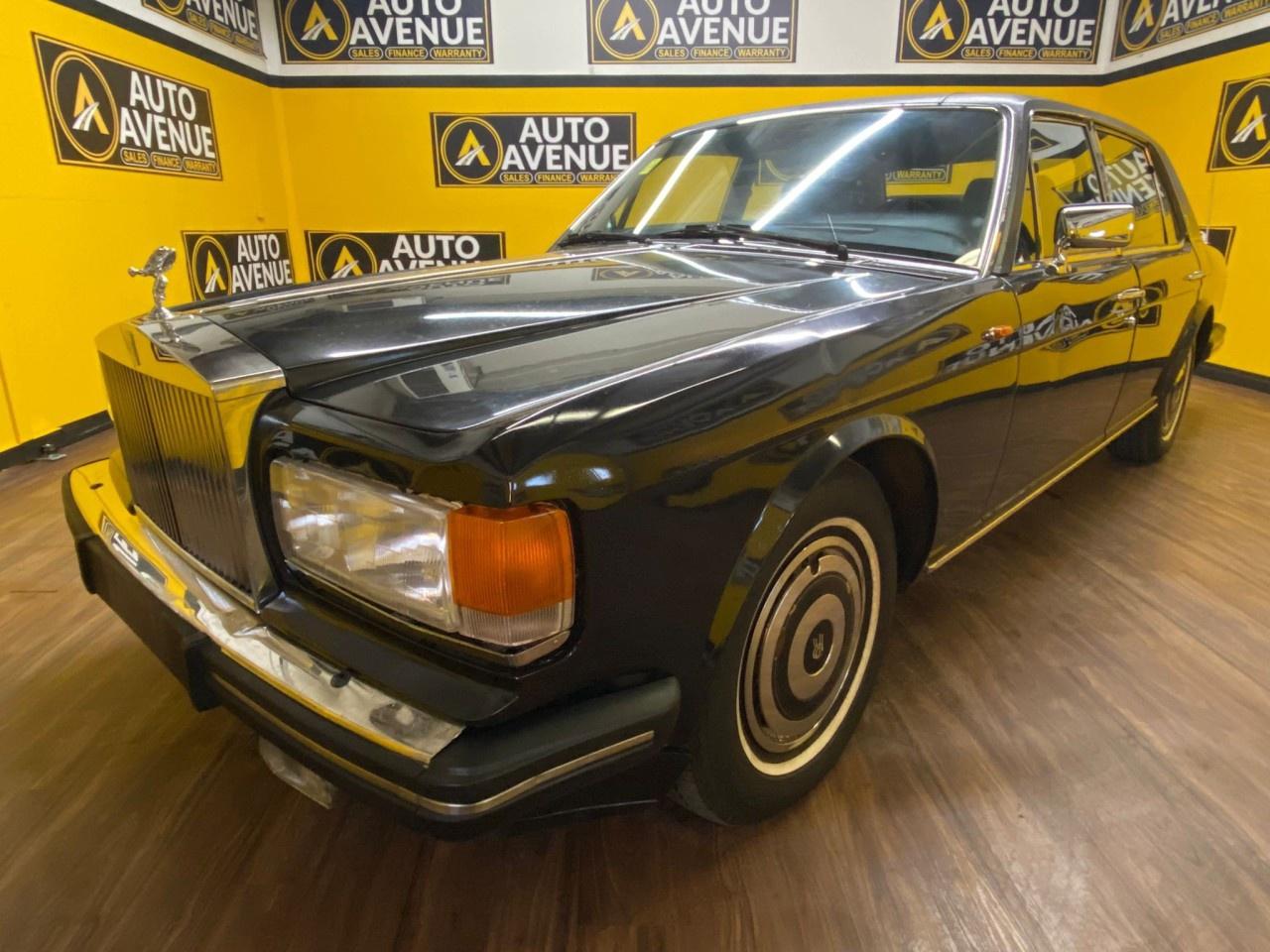 EXPERIENCE TIMELESS LUXURY AND ICONIC BRITISH CRAFTSMANSHIP WITH THIS 1988 ROLLS-ROYCE SILVER SPUR. RENOWNED FOR ITS ELEGANT DESIGN, SMOOTH RIDE, AND HAND-CRAFTED INTERIOR, THIS LUXURY SEDAN DELIVERS A UNIQUE COMBINATION OF COMFORT, STYLE, AND PRESTIGE. STANDARD FEATURES INCLUDE AIR CONDITIONING, POWER WINDOWS AND LOCKS, CRUISE CONTROL, AND HIGH-QUALITY MATERIALS THROUGHOUT THE CABIN FOR A REFINED DRIVING EXPERIENCE. PERFECT FOR COLLECTORS OR ANYONE SEEKING A STATEMENT VEHICLE, THE SILVER SPUR EMBODIES CLASSIC AUTOMOTIVE EXCELLENCE. DON&rsquo;T MISS THIS RARE OPPORTUNITY&mdash;CONTACT US TODAY TO SCHEDULE YOUR PRIVATE VIEWING!<br /><br />AUTO AVENUE IS AN AMVIC LICENSED DEALERSHIP, COMMITTED TO PROVIDING EXCEPTIONAL SERVICE AND QUALITY VEHICLES WITH FLEXIBLE PAYMENT OPTIONS. <br/>