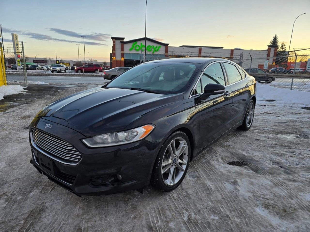 Auto Avenue 17th AVE. is pleased to present this 2015 Ford Fusion Titanium, a well-equipped midsize sedan offering a blend of comfort, capability, and refined driving dynamics. With All-Wheel Drive, this Fusion provides enhanced confidence in a variety of weather and road conditions, contributing to stable handling and a composed ride. <br/> The Titanium trim level adds a range of premium features, creating a comfortable and upscale interior environment. Known for its balanced performance and practical design, the Fusion remains a strong choice for drivers seeking a sedan that delivers both style and everyday functionality. <br/> This well-cared-for example represents a dependable option for anyone looking for a midsize sedan with a solid reputation and thoughtful engineering. For more information or to arrange a viewing, please contact Auto Avenue 17th AVE.<br /><br /> <br/> AUTO AVENUE IS AN AMVIC LICENSED DEALERSHIP, COMMITTED TO PROVIDING EXCEPTIONAL SERVICE AND QUALITY VEHICLES WITH FLEXIBLE PAYMENT OPTIONS. <br/> GIVE US A CALL AT (403) 477-7432 OR EMAIL SALES@AUTOAVENUE.COM. WE&rsquo;RE LOCATED AT 1739 51 STREET SE, CALGARY, AB T2A 1T2. <br/> AUTO AVENUE: YOUR DESTINATION FOR QUALITY CARS AND FLEXIBLE PAYMENTS. <br/>