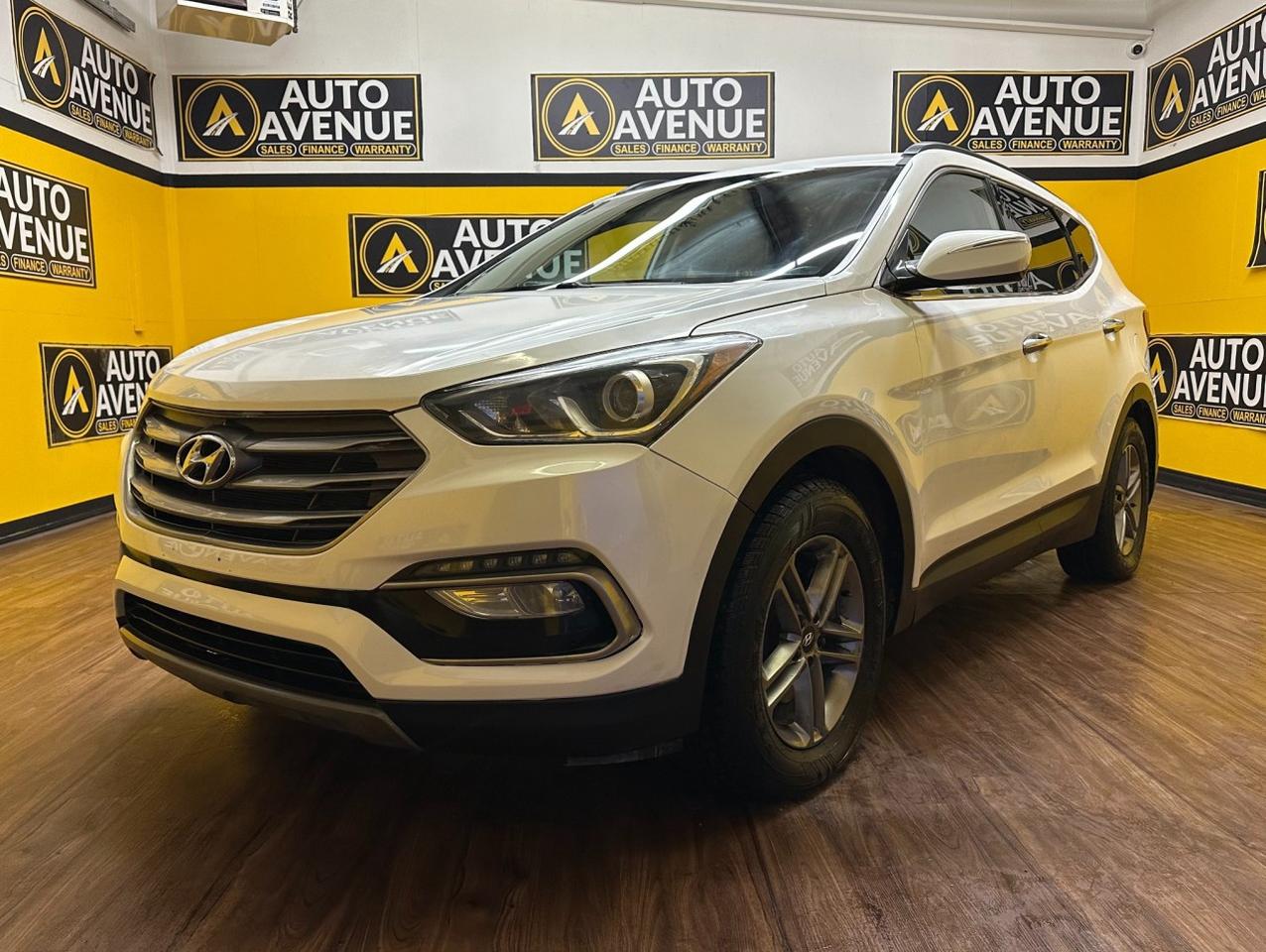Check out this pre-owned 2017 Hyundai Santa Fe Sport we recently got in. <br/> On almost any road condition, this Hyundai Santa Fe Sport - HEATED SEATS! BACKUP CAMERA! delivers confident performance, proven reliability, and everyday comfort. Equipped with AWD, it handles changing weather and road conditions with ease, offering superb stability, responsive steering, and smooth acceleration. <br/> The look is unmistakably Hyundai. Sleek contours, a bold stance, and modern technology give this Santa Fe Sport a design that truly stands out. Spacious, comfortable, and well-equipped, it&rsquo;s an SUV built to handle daily driving and weekend adventures alike. <br/> You can finally stop searching - you&rsquo;ve found the one you&rsquo;ve been looking for.<br /><br /> <br/> AUTO AVENUE IS AN AMVIC LICENSED DEALERSHIP, COMMITTED TO PROVIDING EXCEPTIONAL SERVICE AND QUALITY VEHICLES WITH FLEXIBLE PAYMENT OPTIONS. <br/> GIVE US A CALL AT (403) 477-7432 OR EMAIL SALES@AUTOAVENUE.COM. WE&rsquo;RE LOCATED AT 1739 51 STREET SE, CALGARY, AB T2A 1T2. <br/> AUTO AVENUE: YOUR DESTINATION FOR QUALITY CARS AND FLEXIBLE PAYMENTS. <br/>