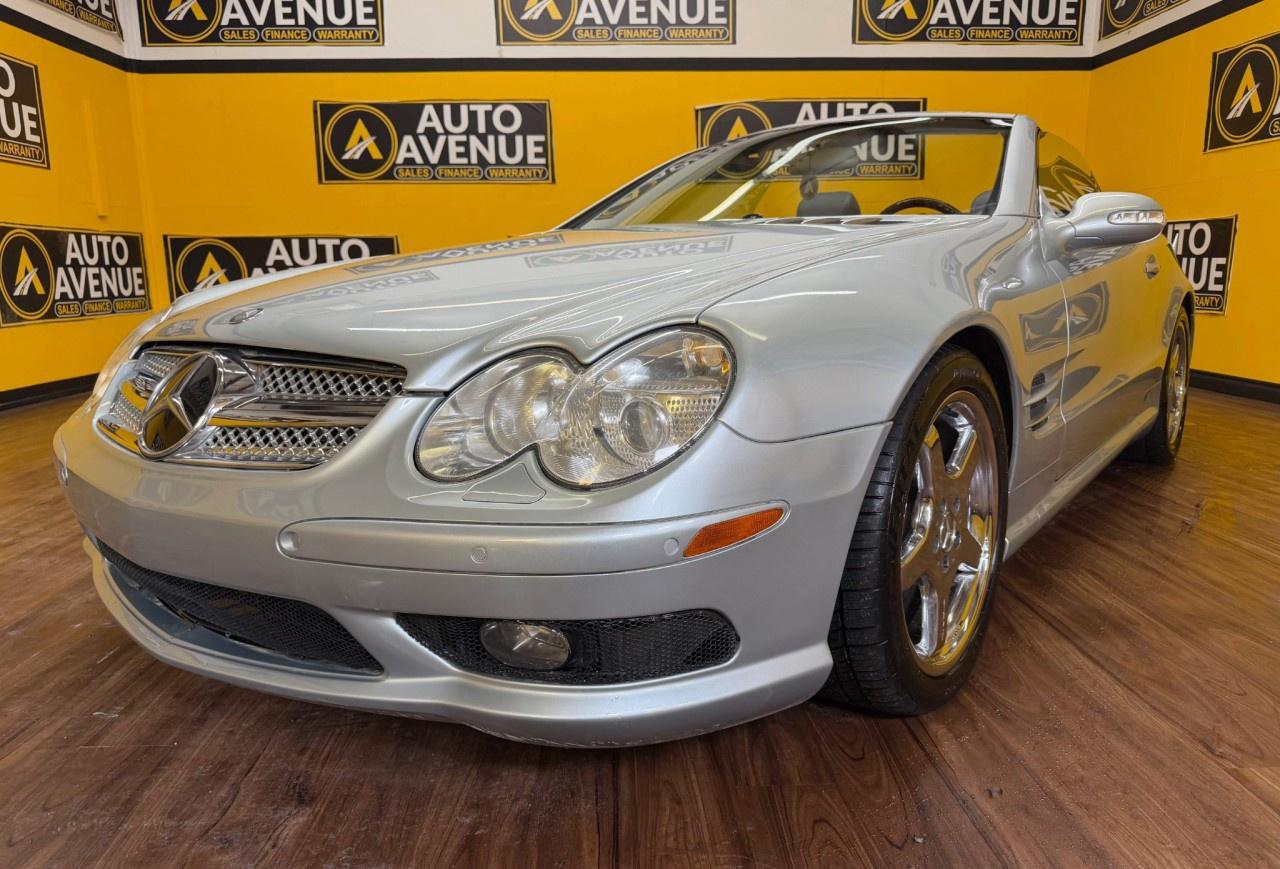 Auto Avenue Airdrie is proud to present this timeless 2003 Mercedes-Benz SL-Class V8. <br/> Elegant, powerful, and undeniably iconic, this low-mileage luxury roadster stands as a true testament to refined German engineering. With barely any wear, it offers a rare opportunity to own a classic that feels remarkably close to new. Your search for the perfect blend of performance and prestige ends here. <br/> Crafted for those who expect nothing but the best, the SL-Class delivers an exhilarating driving experience with its robust 5.0L V8 engine, while maintaining the smooth, composed ride Mercedes-Benz is known for. With the touch of a button, it transforms effortlessly into a convertible&mdash;ready to elevate every sunny drive into something unforgettable. <br/> Inside, you&rsquo;re welcomed by a meticulously appointed cabin featuring premium leather, heated seats, and an intuitive navigation system - ensuring comfort, convenience, and confidence on every journey. Every detail reflects a commitment to luxury, sophistication, and driver-focused design. <br/> From its sleek, commanding presence to its finely crafted interior, this SL-Class is more than just a vehicle - it&rsquo;s a statement of style, performance, and timeless class. <br/> If you&rsquo;re looking for a car that blends open-air freedom with uncompromising luxury, this 2003 Mercedes-Benz SL-Class isn&rsquo;t just a car - it&rsquo;s an experience. <br/> Timeless Design. V8 Power. Open-Top Freedom. Mercedes-Benz. | Auto Avenue Airdrie<br /><br />AUTO AVENUE IS AN AMVIC LICENSED DEALERSHIP, COMMITTED TO PROVIDING EXCEPTIONAL SERVICE AND QUALITY VEHICLES WITH FLEXIBLE PAYMENT OPTIONS. <br/>