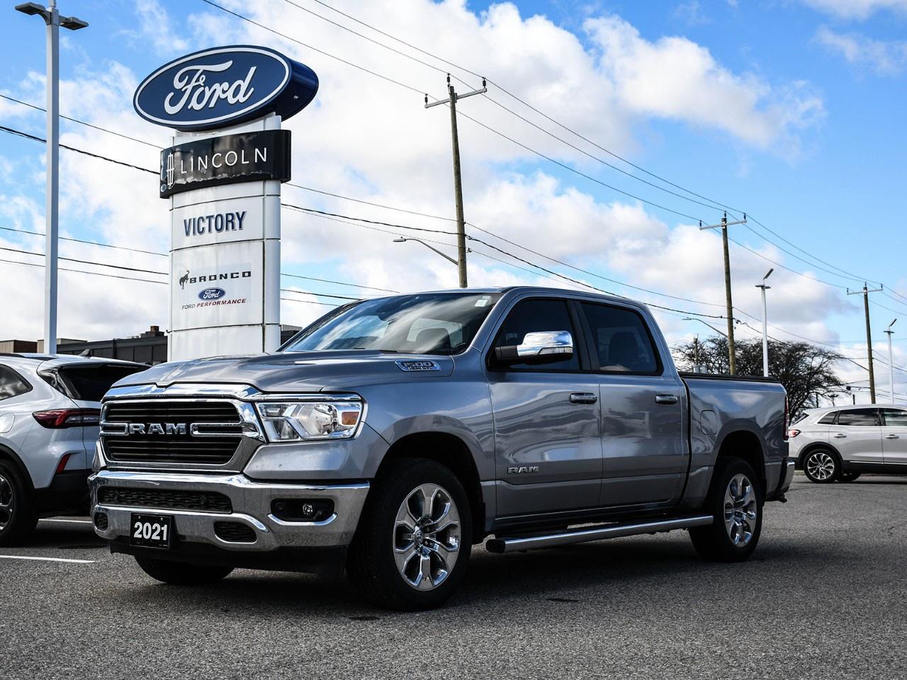 <h2>NOW AVAILABLE AT VICTORY FORD LINCOLN</h2><h1>2021 Ram 1500 Big Horn</h1><h3>Big Horn Level 2 Equipment Group  5.7L HEMI V8  Alpine Sound System  Navigation</h3><p>This 2021 Ram 1500 Big Horn delivers powerful performance, bold styling, and a well-equipped interior. Featuring the Big Horn Level 2 Equipment Group, legendary 5.7L HEMI V8, premium Alpine sound system, and built-in navigation, this truck is built to handle both work and everyday driving with comfort and capability.</p><h3>POWER & PERFORMANCE</h3><ul><li><p>5.7L HEMI V8 Engine</p></li><li><p>8-Speed Automatic Transmission</p></li><li><p>Rear-Wheel Drive / Available 4x4 Capability</p></li><li><p>Strong Towing & Hauling Capability</p></li><li><p>Smooth and Responsive Power Delivery</p></li></ul><h3>BIG HORN LEVEL 2 EQUIPMENT GROUP</h3><ul><li><p>Heated Front Seats</p></li><li><p>Heated Steering Wheel</p></li><li><p>Power Driver Seat</p></li><li><p>Remote Start System</p></li><li><p>Power Adjustable Pedals</p></li><li><p>Rear Window Defroster</p></li><li><p>Rear Power Sliding Window</p></li></ul><h3>EXTERIOR FEATURES</h3><ul><li><p>Chrome Exterior Accents</p></li><li><p>LED Lighting</p></li><li><p>Fog Lights</p></li><li><p>Trailer Hitch Ready</p></li><li><p>Alloy Wheels</p></li><li><p>Bold Ram Styling</p></li></ul><h3>INTERIOR & COMFORT</h3><ul><li><p>Premium Cloth Seating</p></li><li><p>Dual-Zone Climate Control</p></li><li><p>Spacious Crew Cab Interior</p></li><li><p>Rear Under-Seat Storage</p></li><li><p>Fold-Up Rear Seats</p></li><li><p>Ample Cabin Storage</p></li></ul><h3>TECHNOLOGY</h3><ul><li><p>Uconnect® Infotainment System</p></li><li><p>Large Touchscreen Display</p></li><li><p>Built-In Navigation System</p></li><li><p>Apple CarPlay® & Android Auto</p></li><li><p>Alpine® Premium Sound System</p></li><li><p>Bluetooth® Connectivity</p></li><li><p>USB Charging Ports</p></li></ul><h3>SAFETY & DRIVER ASSISTANCE</h3><ul><li><p>ParkView® Rear Back-Up Camera</p></li><li><p>Electronic Stability Control</p></li><li><p>Traction Control System</p></li><li><p>Trailer Sway Control</p></li><li><p>Advanced Multistage Airbags</p></li><li><p>Rear Parking Sensors</p></li></ul><h3>HIGHLIGHTS</h3><ul><li><p>Big Horn Level 2 Equipment Group</p></li><li><p>5.7L HEMI V8 Power</p></li><li><p>Alpine Premium Audio System</p></li><li><p>Navigation System</p></li><li><p>Comfortable & Capable Truck</p></li><li><p>Great for Work or Daily Driving</p></li></ul><h3>Special Offer:</h3><p><strong>Peace of Mind Included:</strong> 3-Month Comprehensive Warranty (for vehicles under 10 years old & under 160,000 km) No-Haggle, Live Market Pricing  Transparent & Competitive All-Inclusive Pricing: Fees, Reconditioning, and Full Detailing Included (Taxes & Licensing Extra)</p><h4>Additional Details:</h4><p><strong>Keys:</strong> Standard with one key. Additional keys (if provided by the previous owner) included at no cost. Optional key purchases available upon request.</p><p><strong>Visit Victory Ford Lincoln Today</strong> Schedule your appointment to experience this exceptional vehicle.</p>