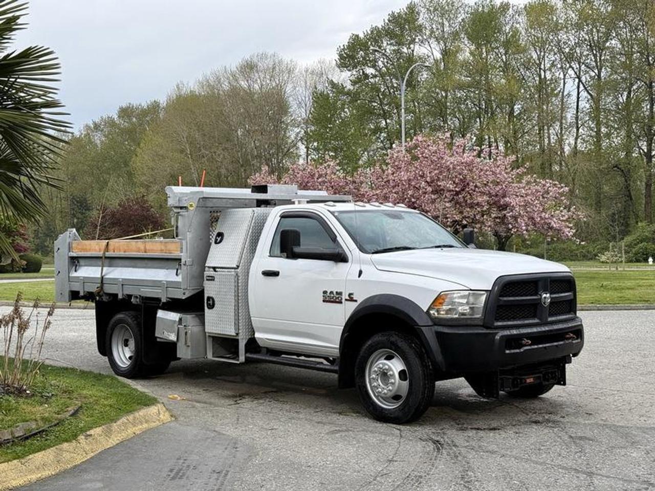 This 2016 Ram 5500 regular cab 4x4 dump truck is powered by a 6.7L Cummins inline-6 diesel paired with an automatic transmission and dual rear wheel configuration, offering a capable setup for heavy-duty work and winter operations. It features a 9-foot by 8-foot hydraulic dump box with tarp, along with plow-ready equipment including quick-connect hydraulic lines and Cirus controls for dump and plow functions. Additional equipment includes PTO, exhaust brake, trailer brake controller, strobe lights, cruise control, air conditioning and heat, AM/FM radio, and power windows, power door locks, and power mirrors. Finished in white with a grey vinyl interior, this truck provides a practical and well-equipped solution for construction, snow removal, or fleet use. This item is currently OFFSITE. You must register an appointment with our office to schedule an offsite viewing. Appointments must be made a minimum of one business day in advance (and as defined by the days that Repo.com is open for business) before your appointment can be scheduled and confirmed. We may, at our own discretion, instead opt to transport smaller items to Repo.coms main yard for viewing purposes.  $57,870.00 plus $375 processing fee, $58,245.00 total payment obligation before taxes.   Listing report, warranty, contract commitment cancellation fee, financing available on approved credit (some limitations and exceptions may apply). All above specifications and information is considered to be accurate but is not guaranteed and no opinion or advice is given as to whether this item should be purchased. We do not allow test drives due to theft, fraud, acts of vandalism and undetectable impaired driving. Instead we provide the following benefits: Complimentary Warranty (with options to extend), Limited Money Back Satisfaction Guarantee on Fully Completed Contracts, Contract Commitment Cancellation, and an Open-Ended Sell-Back Option. Ask seller for details or call 604-522-REPO(7376) to confirm listing availability.