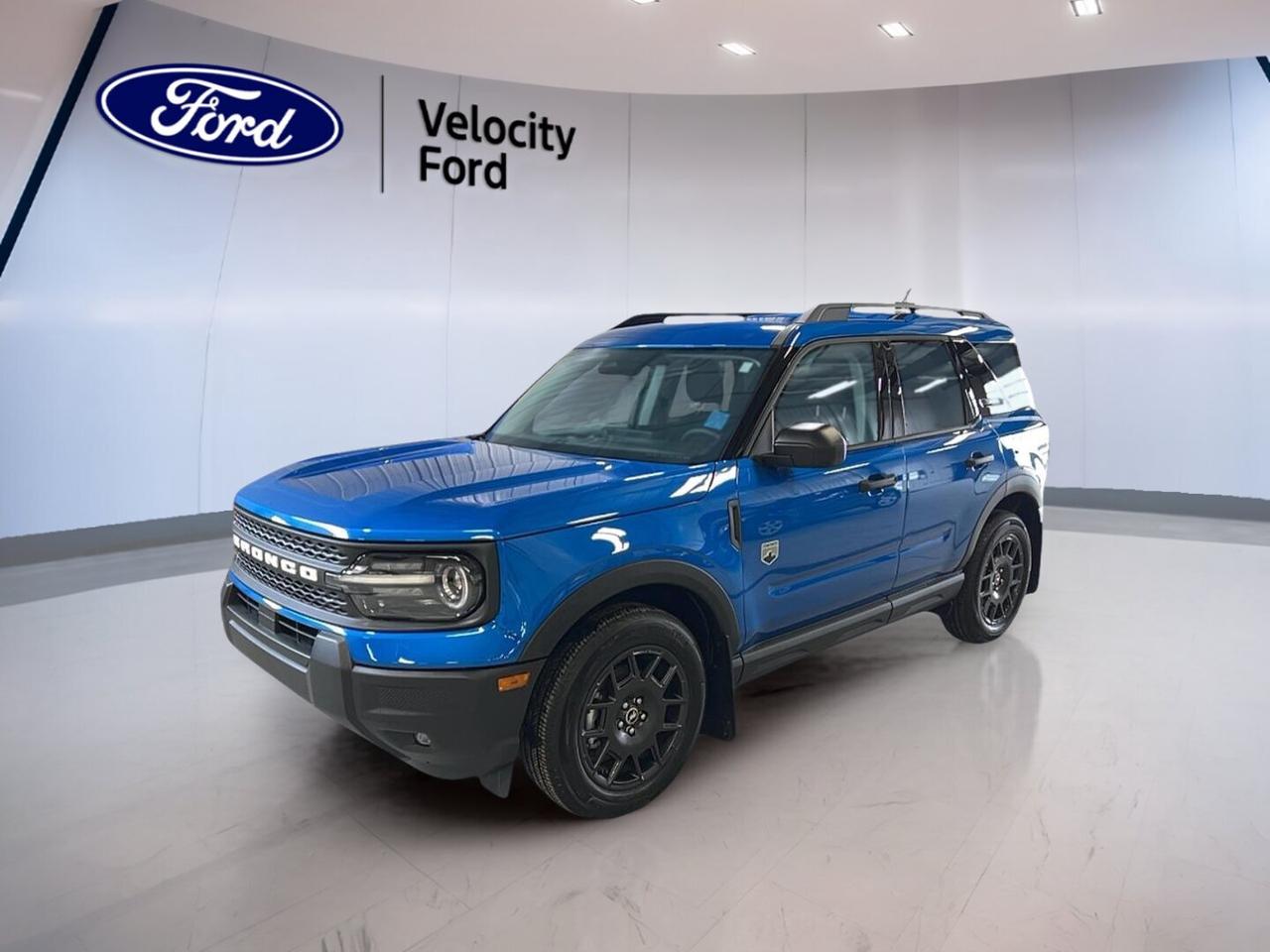 Brand new and ready for Saskatchewan roads, this 2026 Ford Bronco Sport Big Bend 4x4 at Velocity Ford in Moose Jaw brings everyday comfort, useful technology, and true four-wheel-drive confidence in one smart SUV. Its blue exterior and green interior give it a fresh look, while the 1.5-litre unleaded engine and 8-speed automatic transmission deliver smooth, easy driving.

With four doors, practical cabin space, and a well-chosen list of features, this 2026 Ford Bronco Sport Big Bend 4x4 is built for daily commuting, weekend travel, and changing weather. It offers the capability drivers want, along with key safety and convenience equipment that helps make every trip feel simple and secure.

FEATURES OF THE Bronco Sport Big Bend 4x4
»» Four-wheel drive for added road confidence
»» 1.5-litre unleaded engine balances daily efficiency
»» Eight-speed automatic supports smooth shifting
»» Four-door SUV layout adds easy access

ADVANCED SAFETY FEATURES
»» Anti-lock braking system helps controlled stops
»» Stability control supports confident handling
»» Lane departure warning adds driving awareness
»» Blind spot monitor helps safer lane changes

PERFORMANCE AND EFFICIENCY
»» 1.5-litre engine delivers practical everyday power
»» Automatic transmission provides smooth acceleration
»» Four-wheel drive improves traction on surfaces
»» Cruise control supports relaxed highway travel

COMFORT AND CONVENIENCE
»» Heated front seats add cold-weather comfort
»» Automatic climate control keeps cabin comfortable
»» Power driver seat adds easy adjustment
»» Push button start simplifies daily departures

TECHNONOLGY AND CONNECTIVITY
»» Bluetooth integration supports hands-free communication
»» WiFi hotspot keeps devices better connected
»» Satellite radio expands in-cabin entertainment choices
»» Steering wheel audio controls aid convenience

CARGO SPACE
»» Rear trunk access helps simple loading
»» Four-door design supports passenger flexibility
»» Power windows add everyday cabin ease
»» Useful SUV shape suits daily gear

WHAT OTHER OWNERS LIKE
»» Easy-to-drive size suits city parking
»» Four-wheel drive inspires winter confidence
»» Heated seats improve cold morning comfort
»» Practical cargo room fits active lifestyles

This new 2026 Ford Bronco Sport Big Bend 4x4 also includes a backup camera for easier parking, automatic headlights for added peace of mind, LED headlamps for clear visibility, and tire pressure monitoring to help you stay informed. Heated mirrors, electric mirrors, tinted windows, and a rear window defroster add welcome convenience through changing Canadian seasons.

Inside, this 2026 Ford Bronco Sport Big Bend 4x4 is designed to keep daily driving simple. Front air conditioning, an adjustable steering wheel, drivers seat lumbar support, illuminated vanity mirrors, automatic door locks, and passenger airbag sensor coverage all help create a cabin that feels practical and ready for real life.

For families and commuters alike, this 2026 Ford Bronco Sport Big Bend 4x4 adds reassuring protection with driver airbag, passenger airbag, side impact airbags, head side airbags, and child safety locks. Power steering and ABS also help support a confident feel behind the wheel, whether you are driving in town or heading out on the highway.

This 2026 Ford Bronco Sport Big Bend 4x4s VIN is: 3FMCR9BN7TRE36294.