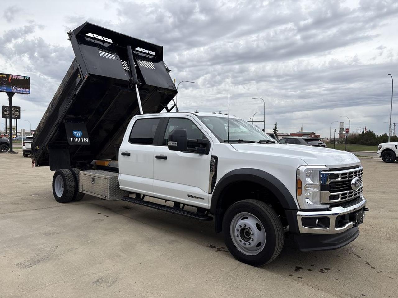THE PRICE YOU SEE, PLUS GST. GUARANTEED!APPLE CARPLAY/ANDROID AUTO COMPATABLE! 6.7 LITER POWERSTROKE DIESEL V8, 10 SPEED AUTO, XL TRIM(660a), MEDIUM DARK SLATE CLOTH SEATS, PLATFORM RUNNING BOARDS, HIGH CAPACITY TRAILER TOW PKG, PAYLOAD PLUS UPGRADE 1, XL CHROME PKG, FOG LAMP, REMOTE START, TRAILER BRAKE CONTROL, 410 AMP ALTERNATOR, DUAL BATTERY, EXTERIOR BACK UP ALARM,    DUMP BODY, 4.30 REAR AXLE RATIO.CARGO VAN BODY WITH HYRAULIC LIFTGATE.      The 2025 Ford F-550 XL with the 6.7-liter turbo diesel engine, the XL Chrome Package, and the 660A package with a dump body installed is a highly capable and durable heavy-duty truck designed for demanding commercial and industrial applications. The 6.7-liter Power Stroke turbo diesel engine provides exceptional torque and towing capacity, making it ideal for hauling heavy loads, towing equipment, or supporting construction and utility work. The XL Chrome Package adds functional style and durability with chrome accents on the grille, bumpers, and side mirrors, enhancing the trucks rugged appearance while offering some corrosion resistance. The 660A package is a comprehensive option that includes advanced features such as an upgraded interior with improved comfort, technology upgrades, and additional utility options tailored to worksite needs. The installed dump body transforms the F-550 into a versatile workhorse, perfect for transporting and unloading bulk materials like gravel, dirt, or debris efficiently. Overall, this configuration of the 2025 F-550 XL combines raw power, practical utility, and a professional appearance, making it an excellent choice for heavy-duty tasks and demanding work environments.Do you want to know more about this vehicle, CALL, CLICK OR COME ON IN!*AMVIC Licensed Dealer; CarFax and Full Mechanical Inspection Included.