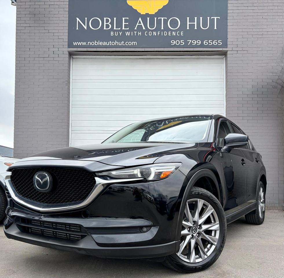 <p><strong>2021 MAZDA CX-5 GT w/Turbo AWD,</strong> KEYLESS ENTRY, LANE DEPARTURE WARNING, HEATED SEATS, &nbsp;BACKUP CAMERA, DRIVE MODES, BLIND SPOT MONITORING ,REAR CROSS TRAFIC ALERT LANE KEEP ASSIST SYSTEM ,ANDROID/APPLE CARPLAY, CLEAN CARFAX AND MUCH MORE.</p><p><strong>HST and Licensing will be extra**</strong></p><p><strong>&bull; On Financed Deals:&nbsp;</strong>We must call this a &ldquo;Finance Fee&rdquo;. It will be a separate line item on the documentation. This fee has already been included in any payment quote advertised by Noble Auto Hut. Our&nbsp;<strong><em>Finance Fee</em></strong>&nbsp;is&nbsp;<strong><em>$999.</em></strong></p><p>&bull; Vehicles sold at Noble Auto Hut are&nbsp;<strong>sold &ldquo;As-Is&rdquo;&nbsp;</strong>and are subject to an optional&nbsp;<strong>Safety Inspection Fee of $799.&nbsp;<em>This vehicle is being sold &ldquo;as-is&rdquo;, unfit, not e-tested and is not represented as being in a road worthy condition, mechanically sound or maintained at any guaranteed level of quality. The vehicle may not be fit for use as a means of transportation and may require substantial repairs at the purchaser&rsquo;s expense. It may not be possible to register the vehicle to be driven in its current condition.</em></strong></p><p><strong>OMVIC FEE&nbsp;</strong></p><p>Ontario Motor Vehicle Industry Council&nbsp;<strong>charges each person in Ontario $22 when they make a vehicle purchase.</strong></p><p><strong>Licensing Fee&nbsp;</strong></p><p>Noble Auto Hut will facilitate the registration of your new vehicle with Service Ontario. We simply ask to be reimbursed for the cost of registration. This is a common practice when purchasing a vehicle.&nbsp;<strong>$32&nbsp;</strong>to attach your existing license plates to your new vehicle.&nbsp;<strong>$59&nbsp;</strong>to purchase and register new license plates to your new vehicle. Heavy-duty and Commercial Vehicles have varying costs of registration depending on weight and usage.</p><p><strong>Noble Auto Hut Inclusions Explained</strong></p><p><strong>Safety Inspection&nbsp;</strong>Noble Auto Hut will perform an Ontario Safety Standards Inspection on each vehicle at time of sale. Any repairs required to meet Ontario Safety Standards will be done. Noble Auto Hut will provide this service for an&nbsp;<strong><u>optional</u>&nbsp;fee of $799</strong>.&nbsp;</p><p><strong>Keys:&nbsp;</strong>Noble Auto Hut guarantees at least 1 operational key with each vehicle. In the case that a client would like additional keys, they will be made available at our industry wholesale pricing.</p><p><strong>On Cash Deals:&nbsp;</strong>We must call this a &ldquo;Cash Purchase Surcharge&rdquo;. It will be added to the selling price of the vehicle on the documentation.&nbsp;Our&nbsp;<strong><em>Cash Purchase Surcharge</em></strong>&nbsp;is&nbsp;<strong><em>$999.</em></strong></p><p><strong>Vehicle History:</strong>&nbsp;CarFax Vehicle History Reports are readily available when requested. We are happy to provide clients with everything required for them to make an informed decision.</p><p><strong>Fuel & Detail:&nbsp;</strong>Each vehicle will be delivered to its new owner with at least half a tank of fuel and will be fully detailed prior to the client taking delivery.</p><p><strong>15 HALE RD.&nbsp;</strong><strong>Brampton&nbsp;</strong>Come in for a test drive and speak to our sales staff, who will look after all your automotive needs with a friendly, low-pressure approach. Get approved and drive away in your new ride today!</p><p>FINANCING AVAILABLE AT AS LOW AS 6.99% O.A.C</p><p>WE WELCOME EVERYONE-GOOD/BAD CREDIT, NEWCOMERS, STUDENTS. EVERYONE IS APPROVED.</p><p>PREVIOUSLY DECLINED BY BANK ? NO PROBLEM&nbsp;</p><p>LET THE EXPERIENCED PROFESSIONALS HANDLE YOUR CREDIT APPLICATION.&nbsp;</p><p>APPLY FOR PRE-APPROVAL TODAY!!</p><h4>Warranty</h4><p>36 DAY/1000 KMS WARRANTY ON SAFETY ITEMS.</p><p>EXTENDED WARRANTY AND GAP INSURANCES ARE AVAILABLE ON REQUEST</p>