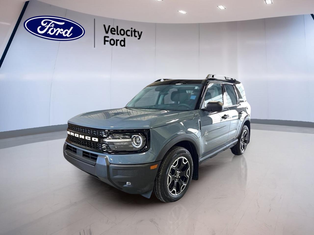 Built for daily comfort and weekend adventure, this brand new 2026 Ford Bronco Sport Outer Banks 4x4 is ready for life in Moose Jaw. It pairs a Grey exterior with a Blue interior, four doors, and an easy-driving 8-speed automatic transmission. The 1.5-litre unleaded engine and four-wheel drive layout give this SUV confident year-round capability.

FEATURES OF THE Bronco Sport Outer Banks 4x4

»» Grey exterior with Blue interior theme
»» 1.5-litre engine with 8-speed automatic
»» Four-wheel drive for added traction
»» Four-door SUV with modern utility

ADVANCED SAFETY FEATURES

»» Backup camera helps with reversing confidence
»» Blind spot monitor supports safer lane changes
»» Lane departure warning adds daily reassurance
»» Side and head airbags enhance protection

PERFORMANCE AND EFFICIENCY

»» 1.5-litre unleaded engine balances everyday efficiency
»» 8-speed automatic supports smooth shifting performance
»» Four-wheel drive adds traction in weather
»» Power steering helps easy city manoeuvres

COMFORT AND CONVENIENCE

»» Heated front seats add cold-weather comfort
»» Dual-zone climate control helps personalized comfort
»» Remote starter warms cabin before driving
»» Driver memory settings simplify repeat use

TECHNONOLGY AND CONNECTIVITY

»» Bluetooth integration supports hands-free phone use
»» Wi-Fi hotspot keeps devices connected
»» Satellite radio expands in-car entertainment choices
»» Steering wheel audio controls ease access

CARGO SPACE

»» Rear trunk access helps everyday loading
»» Four-door layout improves passenger entry ease
»» Flexible SUV cabin suits daily errands
»» Useful cargo room for gear and groceries

WHAT OTHER OWNERS LIKE

»» Easy-to-drive size for urban use
»» Comfortable ride for daily commuting
»» Useful cargo area for active lifestyles
»» Confident all-weather four-wheel drive traction

This brand new 2026 Ford Bronco Sport Outer Banks 4x4 delivers the right mix of comfort, safety, and utility for Canadian driving. Heated mirrors, electric mirrors, power windows, tinted windows, and automatic door locks add daily ease. Automatic headlights, LED headlamps, fog lights, and a rear window defroster help improve visibility in changing conditions.

Inside, this 2026 Ford Bronco Sport Outer Banks 4x4 is designed to make every trip simple and comfortable. Front air conditioning, automatic climate control, an adjustable steering wheel, drivers seat lumbar support, a power drivers seat, and a power passenger seat help create a comfortable space. Illuminated vanity mirrors and an auto-dimming rearview mirror add practical convenience.

Safety is a clear focus in this 2026 Ford Bronco Sport Outer Banks 4x4. Anti-Lock Braking System, stability control, child safety locks, tire pressure monitoring, driver and passenger airbags, side impact airbags, head side airbags, and a passenger airbag sensor help support peace of mind on every drive.

At Velocity Ford in Moose Jaw, this 2026 Ford Bronco Sport Outer Banks 4x4 stands out as a smart choice for drivers who want modern features without unnecessary complexity. Push-button start, cruise control, memory mirrors, heated mirrors, and a clean, functional cabin make it a practical and appealing SUV for workdays, road trips, and changing Prairie weather.

This 2026 Ford Bronco Sport Outer Banks 4x4s VIN is: 3FMCR9CN5TRE39323.