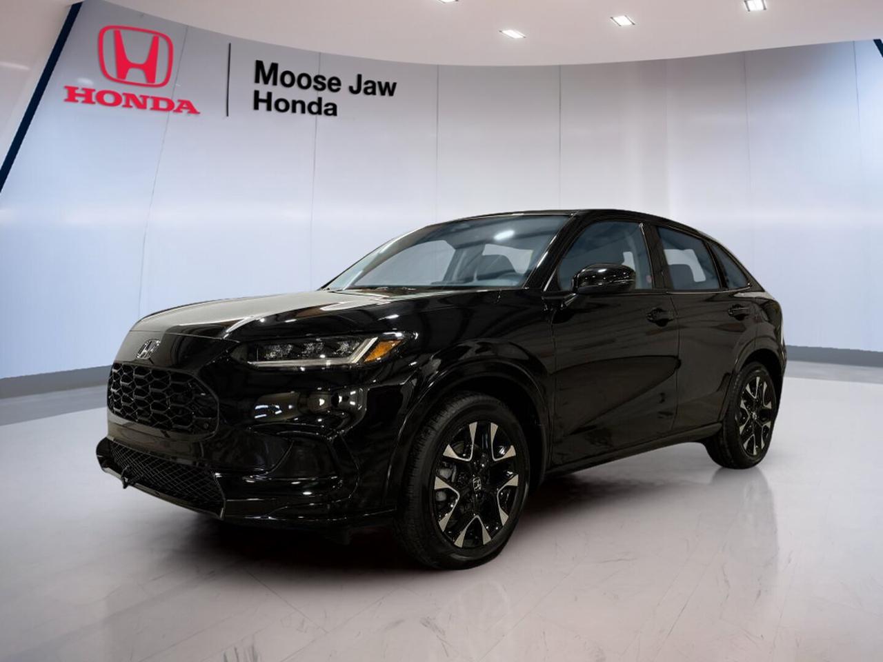 Meet the brand new 2026 Honda HR-V Ex-L at Moose Jaw Honda in Moose Jaw. This compact SUV blends smart size, confident all-wheel drive, and everyday ease. Finished in Black with a Black interior, it delivers a clean, upscale look and the trusted practicality Canadian drivers want all year.

Powered by a 2.0-litre inline 4-cylinder 16-valve DOHC engine with VTEC and paired with a Continuously Variable Transmission, the 2026 Honda HR-V Ex-L is built for smooth response and simple efficiency. Its all-wheel drive system adds extra confidence for changing road and weather conditions around Saskatchewan.

FEATURES OF THE HR-V Ex-L

»» Black exterior with refined SUV presence
»» Black interior with upscale cabin feel
»» All-wheel drive for year-round confidence
»» CVT for smooth daily driving

ADVANCED SAFETY FEATURES

»» Honda Sensing suite supports safer travel
»» Collision mitigation braking helps reduce impacts
»» Lane keeping assist supports steady driving
»» Road departure mitigation adds extra confidence

PERFORMANCE AND EFFICIENCY

»» 2.0-litre VTEC four-cylinder engine power
»» Continuously Variable Transmission delivers smooth acceleration
»» All-wheel drive enhances traction year-round
»» Efficient design suits commuting and errands

COMFORT AND CONVENIENCE

»» Dual-zone climate control adds cabin comfort
»» Spacious layout supports daily passenger ease
»» Easy entry height suits urban driving
»» Quiet ride helps reduce road fatigue

TECHNONOLGY AND CONNECTIVITY

»» Clear infotainment layout keeps controls simple
»» Driver information display supports quick checks
»» Useful connectivity features aid daily routines
»» Modern cabin design feels intuitive throughout

CARGO SPACE

»» Flexible rear cargo area for gear
»» Split rear seating expands carrying options
»» Wide opening helps load larger items
»» Compact size stays easy to park

WHAT OTHER OWNERS LIKE

»» Comfortable ride for daily city driving
»» Useful cargo flexibility for active lifestyles
»» Confident all-wheel drive in winter
»» Easy controls and smooth power delivery

The 2026 Honda HR-V Ex-L is a smart fit for drivers who want value, comfort, and everyday versatility in one well-sized SUV. It feels easy to drive in town, simple to park, and ready for weekend plans, shopping trips, commuting, and changing prairie weather.

Its black-on-black colour combination gives this 2026 Honda HR-V Ex-L a polished and modern appearance. The overall design is clean and confident, while the cabin focuses on practical comfort and user-friendly function. This is an SUV made to fit real life without feeling oversized.

For drivers shopping for a new crossover at Moose Jaw Honda, the 2026 Honda HR-V Ex-L stands out with dependable Honda engineering, practical space, and all-wheel-drive assurance. It is a well-rounded choice for singles, couples, and small families who want everyday usefulness with a more premium feel.

This 2026 Honda HR-V Ex-Ls VIN is: 3CZRZ2H79TM111474.<p>Meet the brand new 2026 Honda HR-V Ex-L at Moose Jaw Honda in Moose Jaw. This compact SUV blends smart size</p>
<p> upscale look and the trusted practicality Canadian drivers want all year.

Powered by a 2.0-litre inline 4-cylinder 16-valve DOHC engine with VTEC and paired with a Continuously Variable Transmission</p>
<p> the 2026 Honda HR-V Ex-L is built for smooth response and simple efficiency. Its all-wheel drive system adds extra confidence for changing road and weather conditions around Saskatchewan.

FEATURES OF THE HR-V Ex-L

»» Black exterior with refined SUV presence
»» Black interior with upscale cabin feel
»» All-wheel drive for year-round confidence
»» CVT for smooth daily driving

ADVANCED SAFETY FEATURES

»» Honda Sensing suite supports safer travel
»» Collision mitigation braking helps reduce impacts
»» Lane keeping assist supports steady driving
»» Road departure mitigation adds extra confidence

PERFORMANCE AND EFFICIENCY

»» 2.0-litre VTEC four-cylinder engine power
»» Continuously Variable Transmission delivers smooth acceleration
»» All-wheel drive enhances traction year-round
»» Efficient design suits commuting and errands

COMFORT AND CONVENIENCE

»» Dual-zone climate control adds cabin comfort
»» Spacious layout supports daily passenger ease
»» Easy entry height suits urban driving
»» Quiet ride helps reduce road fatigue

TECHNONOLGY AND CONNECTIVITY

»» Clear infotainment layout keeps controls simple
»» Driver information display supports quick checks
»» Useful connectivity features aid daily routines
»» Modern cabin design feels intuitive throughout

CARGO SPACE

»» Flexible rear cargo area for gear
»» Split rear seating expands carrying options
»» Wide opening helps load larger items
»» Compact size stays easy to park

WHAT OTHER OWNERS LIKE

»» Comfortable ride for daily city driving
»» Useful cargo flexibility for active lifestyles
»» Confident all-wheel drive in winter
»» Easy controls and smooth power delivery

The 2026 Honda HR-V Ex-L is a smart fit for drivers who want value</p>
<p> and changing prairie weather.

Its black-on-black colour combination gives this 2026 Honda HR-V Ex-L a polished and modern appearance. The overall design is clean and confident</p>
<p> while the cabin focuses on practical comfort and user-friendly function. This is an SUV made to fit real life without feeling oversized.

For drivers shopping for a new crossover at Moose Jaw Honda</p>
<p> and small families who want everyday usefulness with a more premium feel.

This 2026 Honda HR-V Ex-Ls VIN is: 3CZRZ2H79TM111474.</p>