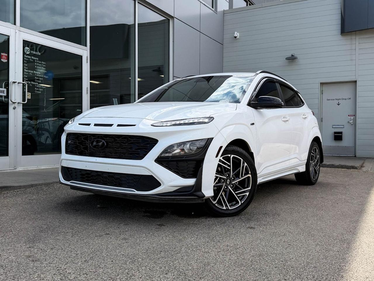 Discover the perfect blend of sporty performance and versatile utility with this pre-owned 2022 Hyundai Kona LE N Line 1.6T AWD in sleek Black interior. Powered by a spirited 1.6L Turbo GDI engine paired with a responsive 7-speed dual-clutch automatic transmission, this Kona offers an engaging drive with full-time all-wheel drive for confident handling in all conditions.Enjoy premium features like heated front bucket seats with woven trim, a sharp 8-inch touchscreen with navigation, SiriusXM audio, and smart device mirroring. Safety and convenience come standard with advanced stability controls, multiple airbags, hill start assist, a rearview camera, and keyless entry with push-button start and remote start.Equipped with 18 alloy wheels wrapped in all-season tires and distinct sporty accents, this Kona LE N Line stands out with a sophisticated yet athletic look. Perfect for daily commutes or weekend adventures, this Hyundai Kona combines confidence, comfort, and technology in one dynamic package.Visit us today to test drive this exciting pre-owned Kona and experience its spirited performance and upscale features firsthand!Go Mazda is an AMVIC licensed businessClean CarFax