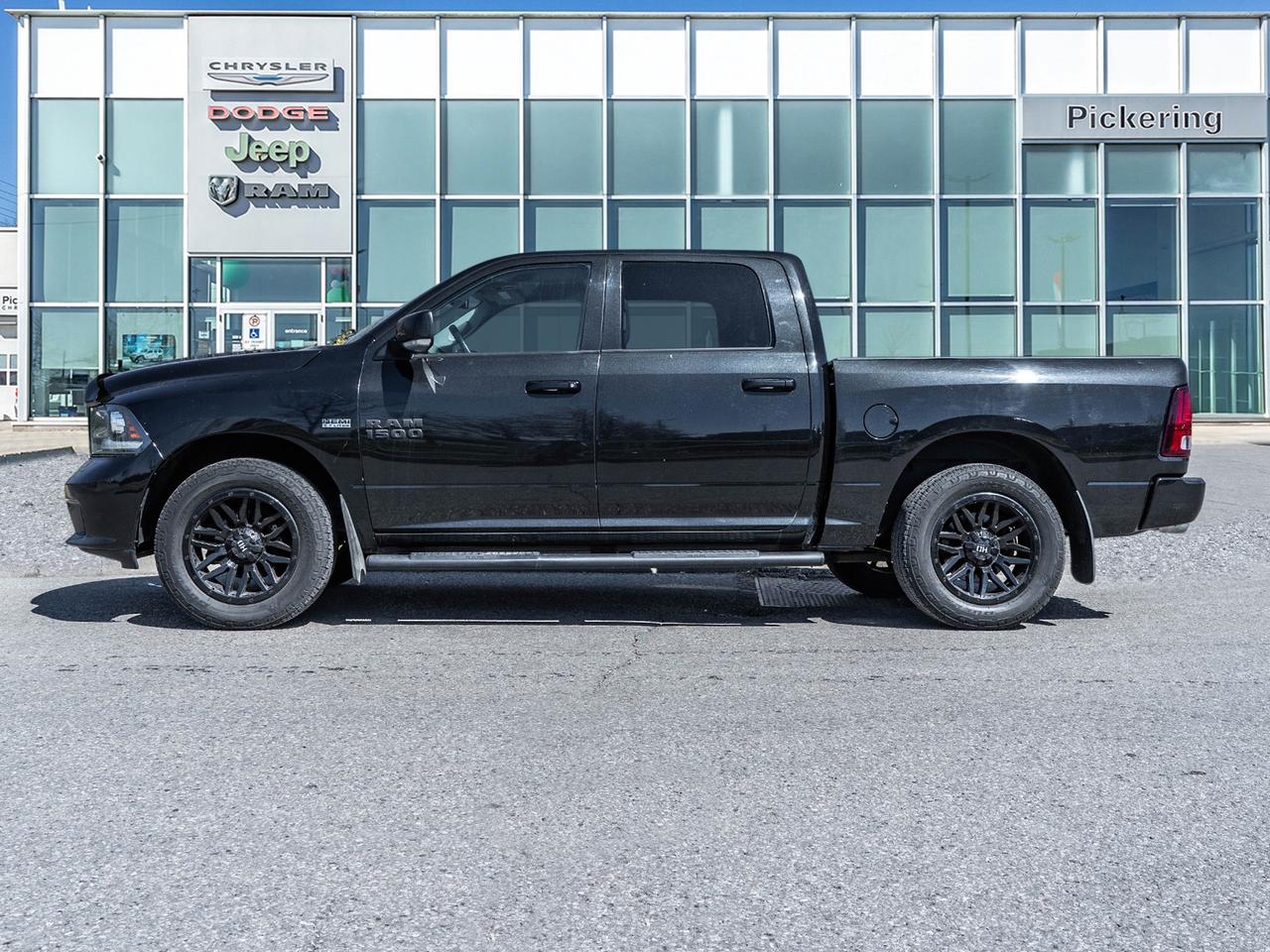 2016 RAM 1500 4WD Crew Cab 140.5  Sport Photo2