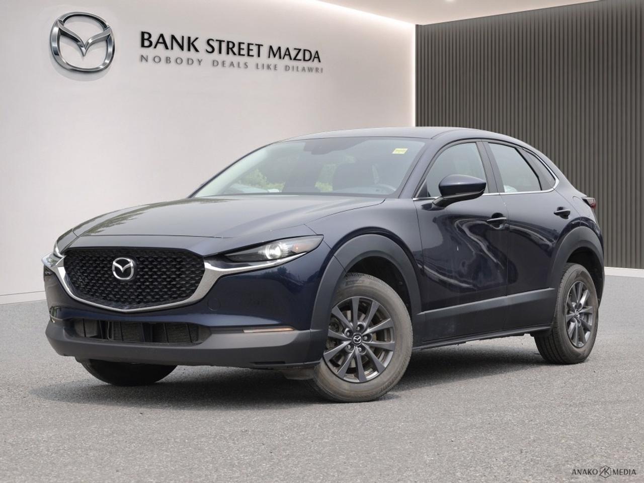 The 2021 Mazda CX-30 GX AWD, dressed in a striking Black finish, offers a confident and composed drive with its all-wheel drive system. Ideal for navigating both urban environments and rugged landscapes, this SUV combines versatility with style. The exterior showcases a modern design with sleek alloy wheels that complement its dynamic silhouette. Inside, the cabin pampers you with an interior trimmed with metal-look instrument panels and leatherette door trims, creating a sophisticated atmosphere. The heated front seats ensure comfort during those chilly Canadian winters. Tech-savvy features abound, making every journey smooth and connected. Stay in touch with smart device integration and enjoy your favorite music via the Bluetooth connection. Safety is paramount with the inclusion of a backup camera and lane assist, providing peace of mind for drivers and passengers alike. Perfectly suited for individuals or small families who value safety, comfort, and style, the Mazda CX-30 GX AWD invites you to elevate your driving experience. Contact our dealership today for more information and to schedule a test drive.
