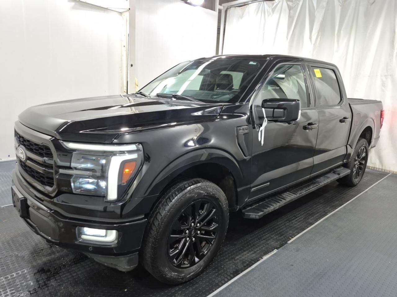 // SINGLE OWNER! //

This 2024 Ford F-150 LARIAT POWERBOOST 4WD SuperCrew 5.5 Box COMING SOON is a smart full-size truck for work and daily life. It has had a single owner, as reported by CARFAX Canada. Finished in Black with a Black interior, this used Ford offers strong hybrid power, four full doors, automatic transmission, and 44,504 km.

Built to handle tough Canadian driving, this Ford F-150 LARIAT POWERBOOST 4WD SuperCrew 5.5 Box COMING SOON blends pickup strength with smooth comfort and useful technology. Its 3.5-litre unleaded engine works with the PowerBoost full hybrid system for confident performance. Four-wheel drive, off-road tires, steps, and retractable mirrors add everyday truck practicality.

FEATURES OF THE F-150 LARIAT POWERBOOST 4WD SuperCrew 5.5 Box COMING SOON
»» PowerBoost full hybrid V6 performance
»» Four-wheel drive for added traction
»» SuperCrew cab with four full doors
»» 5.5-foot box for daily utility

TRUCK FEATURES
»» Towing capacity rated at 4,671 kg
»» Rear tow hook for added utility
»» Off-road tires support rougher terrain
»» Side steps help cabin access

ADVANCED SAFETY FEATURES
»» Backup camera helps with reversing
»» Blind spot monitor boosts lane awareness
»» Lane departure warning adds confidence
»» Side and head airbags included

PERFORMANCE AND EFFICIENCY
»» 3.5-litre unleaded hybrid powertrain
»» Automatic transmission shifts smoothly daily
»» Four-wheel drive improves all-season traction
»» Power steering supports easy manoeuvres

COMFORT AND CONVENIENCE
»» Heated front seats for cold mornings
»» Dual-zone climate control adds comfort
»» Remote starter helps in winter
»» Memory seats save driver settings

TECHNONOLGY AND CONNECTIVITY
»» Navigation system helps guide each trip
»» Bluetooth integration supports hands-free calling
»» WiFi hotspot keeps devices connected
»» Satellite radio and HD Radio included

CARGO SPACE
»» 5.5-foot box handles daily gear
»» Rear trunk access adds convenience
»» Four-door cabin supports passenger flexibility
»» Spare tire included for reassurance

AWARDS & RECOGNITIONS
»» North American Truck of the Year, 2021
»» Awarded by North American Car, Truck and Utility Vehicle of the Year

WHAT OTHER OWNERS LIKE
»» Strong towing and everyday hauling ability
»» Smooth hybrid power and quiet cruising
»» Spacious SuperCrew cabin for passengers
»» Useful tech features for daily driving

This truck also brings many sought-after details that make every drive easier. Cruise control, power windows, power steering, power mirrors, heated mirrors, automatic headlights, fog lights, tinted windows, chrome wheels, LED headlamps, adjustable pedals, and an auto-dimming rearview mirror all help create a well-equipped experience.

Inside, this Ford keeps things simple and functional. Front air conditioning, automatic climate control, steering wheel audio controls, push button start, a leather steering wheel, driver lumbar support, passenger lumbar support, a power driver seat, a power passenger seat, ambient lighting, and illuminated vanity mirrors give the cabin a refined and user-friendly feel.

Safety and control remain a key part of this pickups appeal. Anti-Lock Braking System, stability control, tire pressure monitoring, child safety locks, automatic door locks, turn signal mirrors, a rear window defroster, passenger airbag sensor, and multiple airbags all help support peace of mind on the road.

This 2024 Ford F-150 LARIAT POWERBOOST 4WD SuperCrew 5.5 Box COMING SOONs VIN is: 1FTFW5LD7RFA38808.