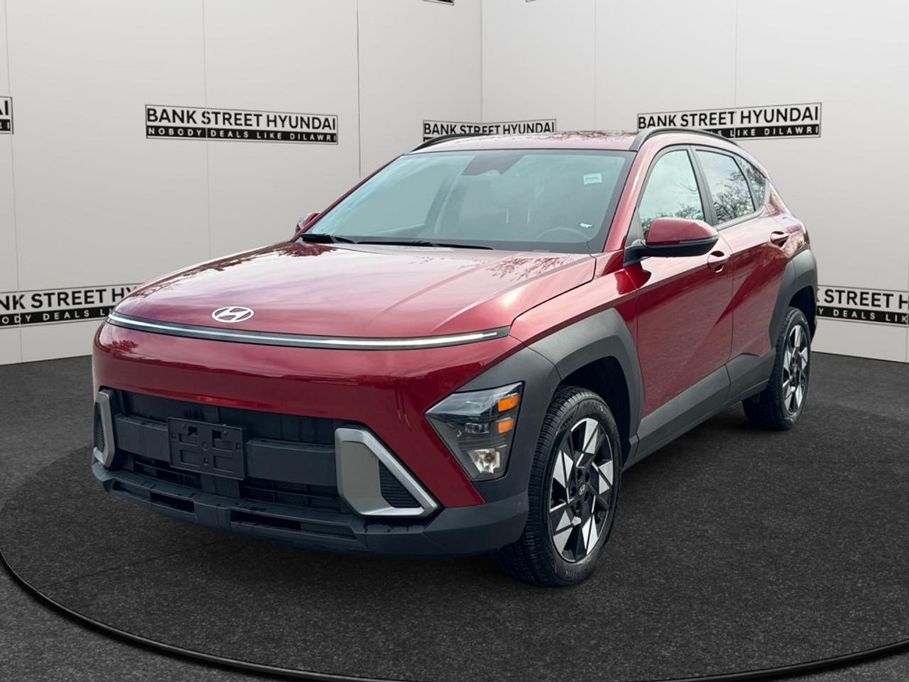 The 2024 Hyundai Kona Preferred in vibrant Red is equipped with a smooth AWD drivetrain and comes with an automatic transmission that ensures an excellent handling experience for SUV enthusiasts. The stylish exterior, enhanced by its alloy wheels, sets the perfect tone for adventure and city driving alike. Inside, this SUV combines comfort with functionalityenjoy the warmth of heated seats, and a leather steering wheel that adds a touch of elegance to your driving. Adaptable and practical, this Kona supports your lifestyle with features such as keyless entry, remote start, and power windows, making every drive as convenient as possible. Technology is seamlessly integrated into your rides, featuring smart device integration, a backup camera for easier maneuvering, and a range of driver assistance options like lane assist and adaptive cruise control. Your safety and comfort are paramount with advanced safety features ensuring peace of mind on the road. This SUV is ideally suited for those who value a blend of style, technology, and performance. Whether you are a family looking for space and safety or a young professional in search of a versatile vehicle, the Hyundai Kona Preferred is an excellent choice. Dont miss the chance to make this versatile SUV your owncontact us today for more details and to schedule a test drive.