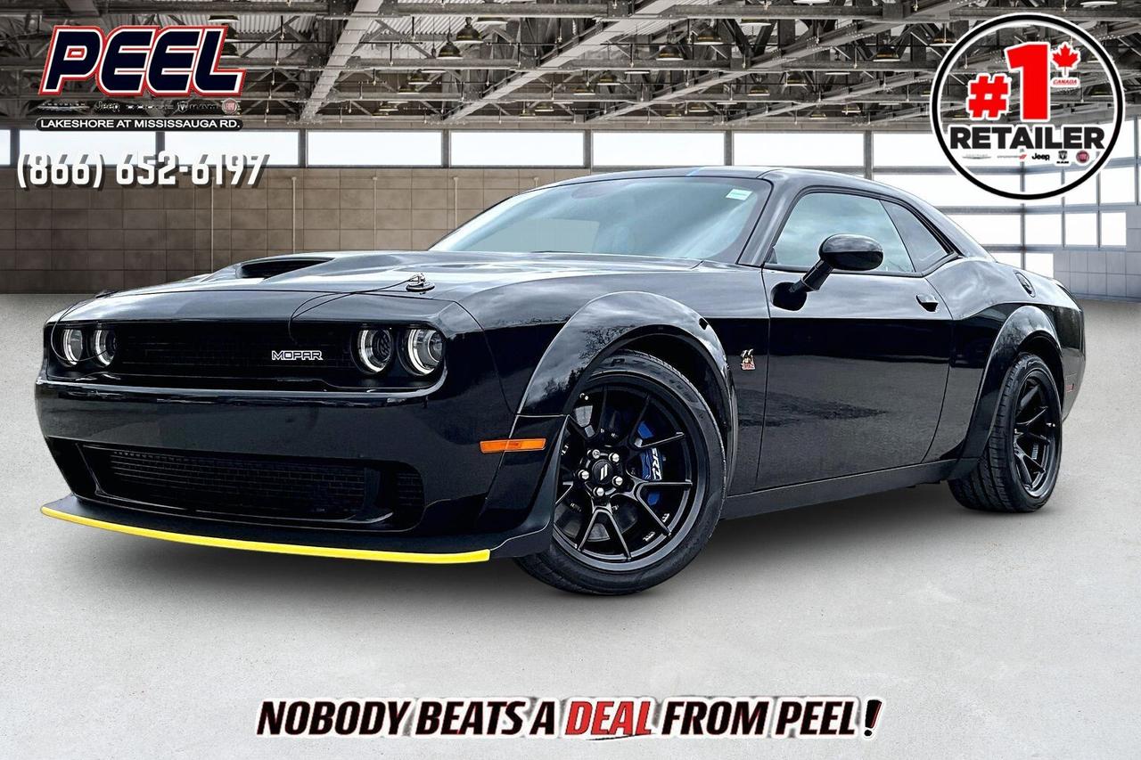 COME SEE WHY NOBODY BEATS A DEAL FROM PEEL! Your Source for ALL make and models used cars and trucks. The True #1 Stellantis Retailer in Ontario for 14 years and running!! (*)

2023 Dodge Challenger Scat Pack 392 Widebody | 6.4L HEMI V8 | Pitch Black | 6-speed TREMEC Manual Transmission | Mopar 23 Special Edition | Numbered Car #77 of 220 | Carbon & Suede Interior Package | Heated & Ventilated Alcantara Bucket Seats | Uconnect 8.4" Touchscreen Display w/ Navigation | Plus Group | Technology Group | Alpine Premoim AUdio System | 20x11 Carbon Black Aluminum Wheels | Brembo 6-piston Brakes | Widebody Fender Flares | Widebody Competition Suspension | Adaptive Damping Suspension | Carbon Fibre SRT Spoiler | Blue Brake Calipers | Carbon Fibre Interior Accents | Dinamica Suede Headliner | Black Mopar Hood Pin Kit | Mopar Front Strut Tower Brace

One Owner Clean Carfax

One of the rarest modern Mopar muscle cars you can actually own, this 2023 Dodge Challenger Scat Pack 392 Widebody Mopar 23 is not just another widebody, it is part of an ultra-limited factory program with only 220 Challengers produced globally and just 20 allocated to Canada, making it a true collector-grade car right from day one . Built on the already iconic Widebody Scat Pack platform, it delivers 485 horsepower and 475 lb-ft of torque from the legendary 6.4L HEMI V8, paired here with the highly sought-after 6-speed TREMEC manual for a pure, connected driving experience that enthusiasts actively chase . Inside, the Mopar 23 package elevates the cabin with the Carbon and Suede Interior Package featuring real carbon fibre trim and a Dinamica suede headliner, heated and ventilated Alcantara seats, and a serialized Mopar instrument panel badge that confirms its numbered status, a detail that separates it instantly from any standard Scat Pack . The Plus and Technology Groups, Alpine premium audio, and Uconnect system with navigation round out a cabin that feels just as premium as it does performance-focused.

Where this car truly stands apart is in the details that only Mopar builds get, finished exclusively in Pitch Black with signature Mopar Blue accents, including blue Brembo brake calipers, unique badging, and an exclusive carbon fibre rear spoiler that was introduced only on the Mopar 23 models, paired with widebody 20x11 carbon black wheels and an SRT-tuned adaptive damping suspension that delivers serious grip and road presence . The widebody stance adds over three inches of width, giving it an aggressive, planted look that matches its performance, while features like the Mopar hood pin kit, front strut tower brace, and performance suspension upgrades reinforce that this is a purpose-built drivers car, not just a cosmetic package. As a numbered car with factory-backed Mopar exclusivity, complete with its original concept and limited production run, this is not just a Challenger, it is a piece of Dodges final era of V8 muscle, making it highly desirable today and even more significant long term for collectors and enthusiasts alike.
______________________________________________________

Engage & Explore with Peel Chrysler: Whether youre inquiring about our latest offers or seeking guidance, 1-866-652-6197 connects you directly. Dive deeper online or connect with our team to navigate your automotive journey seamlessly.

WE TAKE ALL TRADES & CREDIT. WE SHIP ANYWHERE IN CANADA! OUR TEAM IS READY TO SERVE YOU 7 DAYS!
______________________________________________________
Our advertised prices are for consumers (i.e end users) only. 

*FREE CarFax (click the link above to check it out at no cost to you!)*

*FULLY CERTIFIED! (Have you seen some of these other dealers stating in their advertisements that certification is an additional fee? NOT HERE! Our certification is already included in our low sale prices to save you more!)

(*) Based on the Eastern Business Center National Ranking reported sales to actual customers, not including demonstrators.
______________________________________________________

Peel Chrysler  A Trusted Destination: Based in Port Credit, Ontario, we proudly serve customers from all corners of Ontario and Canada including Toronto, Oakville, North York, Richmond Hill, Ajax, Hamilton, Niagara Falls, Brampton, Thornhill, Scarborough, Vaughan, London, Windsor, Cambridge, Kitchener, Waterloo, Brantford, Sarnia, Pickering, Huntsville, Milton, Woodbridge, Maple, Aurora, Newmarket, Orangeville, Georgetown, Stouffville, Markham, North Bay, Sudbury, Barrie, Sault Ste. Marie, Parry Sound, Bracebridge, Gravenhurst, Oshawa, Ajax, Kingston, Innisfil and surrounding areas. On our website www.peelchrysler.com, you will find a vast selection of new vehicles including the new and used Ram 1500, 2500 and 3500. Chrysler Grand Caravan, Chrysler Pacifica, Jeep Cherokee, Wrangler and more. All vehicles are priced to sell. We deliver throughout Canada. website or call us 1-866-652-6197. 

Disclaimer Statement: At Peel Chrysler, your satisfaction is our priority. While many pre-owned vehicles originally come with two keys, variations may occur based on trade-ins, and all Peel Chrysler Pre-Owned Vehicles come standard with one key. Any extras provided by the previous owner will be included with your purchase, and additional keys can be bought at the time of sale. Online prices and payments are for finance purchases. Used vehicles that are being financed are subject to a $499 (^$1500 non-prime) financing fee, while cash purchases (certified cheque, bank draft, or wire transfer) on used vehicles have a $2,000 surcharge ( online price + $2,000). Cash purchases of new vehicles only incur applicable taxes and licensing fees, and those priced above $100,000 (including accessories or add-ons) are subject to a federal luxury tax. Optional finance and lease terms are available, and if trading in a vehicle with an outstanding loan balance requiring Peel Chrysler to facilitate the lien payout, a Lien Payout Fee of $349 applies. Prices, rates, and payments are subject to change without notice. While we strive for accuracy, occasional technical or human errors may occur, so we encourage verifying all vehicle details, including features, options, materials, and specifications, with a Peel Chrysler representative by contacting us or visiting our dealership. Experience seamless convenience with our nationwide delivery options. Visit our website or contact us for more details.