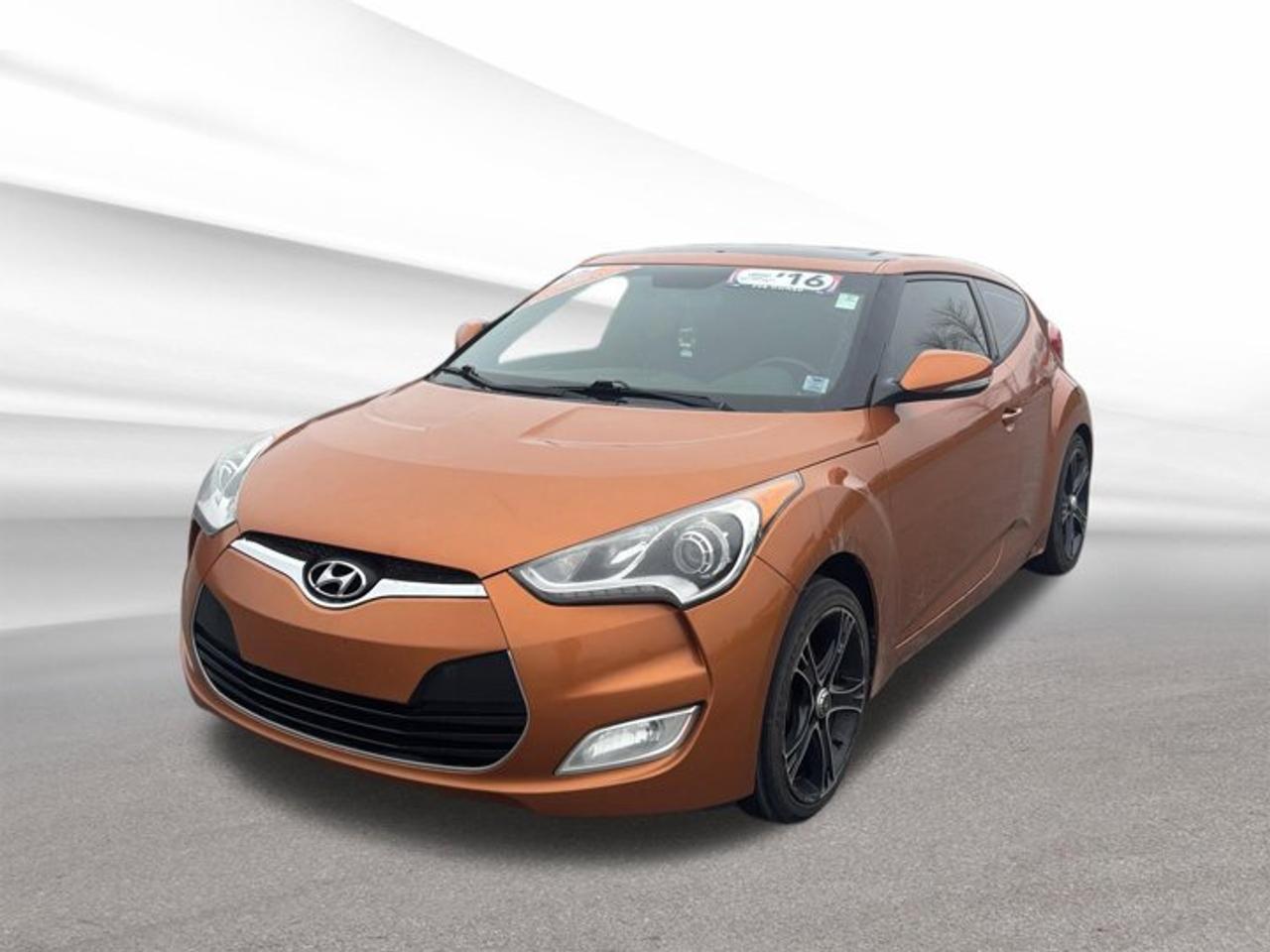 Meet a sporty hatchback that still feels fresh and fun. This 2016 Hyundai Veloster Tech brings bold style, a smart three-door design, and a driver-focused manual transmission. Finished in Vitamin C Pearl with a Black interior, it stands out in Halifax traffic while keeping everyday driving simple and engaging.With 202,659 km, this 2016 Hyundai Veloster Tech shows the kind of versatility that made the Veloster popular with Canadian drivers. Its 1.6-litre regular unleaded four-cylinder engine and front-wheel drive layout deliver balanced efficiency and easy urban handling. At Steele Halifax Chrysler Dodge Jeep Ram FIAT, this used Veloster offers unique character and practical value.FEATURES OF THE Veloster TechUnique three-door coupe hatchback body styleManual transmission adds engaging driver controlFront-wheel drive for confident daily tractionVitamin C Pearl adds bold personalityADVANCED SAFETY FEATURESElectronic stability control helps maintain directionAnti-lock braking system supports controlled stopsMultiple airbags help protect occupants insideTraction control aids grip on slick roadsPERFORMANCE AND EFFICIENCY1.6-litre four-cylinder engine balances fuel economyManual gearbox delivers direct shifting feelFront-wheel drive supports predictable road mannersCompact size helps city parking easeCOMFORT AND CONVENIENCEBlack interior offers clean sporty ambienceThree-door layout improves rear access practicalityHatchback design supports everyday versatility needsCompact footprint suits urban driving routinesTECHNONOLGY AND CONNECTIVITYDriver-focused cabin keeps controls within reachClear gauge layout supports quick readingPractical interior design favours daily usabilityHatchback format blends style with functionCARGO SPACERear hatch allows easy cargo loadingSplit cabin layout supports flexible storageCompact gear fits behind rear seatsEveryday errands feel simple and manageableAWARDS & RECOGNITIONSTop Safety Pick, Insurance Institute for Highway Safety, 2016WHAT OTHER OWNERS LIKEDistinctive styling stands out from trafficManual transmission feels fun and engagingHatchback utility helps with daily errandsCompact size makes parking much easierThe 2016 Hyundai Veloster Tech is a smart choice for drivers who want more personality than a typical compact car. Its coupe-inspired profile, useful hatchback cargo area, and front-wheel drive setup make it well suited to commuting, weekend drives, and life around Halifax.This 2016 Hyundai Veloster Tech also appeals to drivers who enjoy being involved in the drive. The manual transmission gives you more control, while the 1.6-litre gas engine keeps operating costs reasonable. The three-door layout is one of its most recognizable features, blending sporty design with real-world access.Finished in bright Vitamin C Pearl, this used Veloster has a lively look that matches its energetic character. The Black interior keeps the cabin classic and easy to live with. If you want a compact car that delivers style, efficiency, and a more connected feel on the road, this Hyundai deserves a close look.This 2016 Hyundai Veloster Techs VIN is: KMHTC6AD9GU290584.We invite you to book a viewing and test drive at your earliest convenience