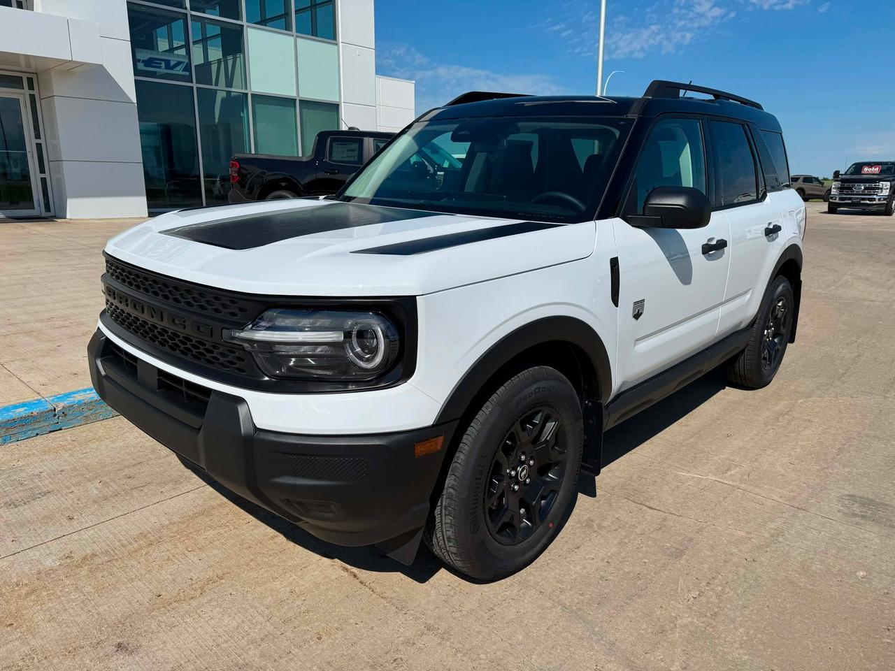 <p>Looking for adventure? Webbs 1441 is thrilled to present a brand-new 2026 Ford Bronco Sport Big Bend 4x4, ready to conquer Canadian roads and beyond. This rugged SUV is built for those who crave exploration, offering a perfect blend of capability, comfort, and style. With its bold design and impressive features, the Bronco Sport Big Bend 4x4 is your ticket to unforgettable experiences.</p><p>&nbsp;</p><p>This Bronco Sport is equipped to handle anything you throw its way. The 4-wheel drive system ensures confident handling in various conditions, while the automatic transmission makes for a smooth and effortless driving experience. The Big Bend trim offers a comfortable interior, perfect for both daily commutes and weekend getaways. This Bronco Sport is ready to go!</p><p>&nbsp;</p><p>Here are five features that make this Bronco Sport stand out:</p><p><br><br></p><ul><li><strong>Black Appearance Package:</strong> Make a statement with this sleek and stylish upgrade.</li></ul><p>&nbsp;</p><ul><li><strong>Unique Graphics Package:</strong> Turn heads with a distinctive look that sets you apart.</li></ul><p>&nbsp;</p><ul><li><strong>1.5L EcoBoost Engine:</strong> Experience a powerful and efficient ride.</li></ul><p>&nbsp;</p><ul><li><strong>Convenience Package:</strong> Enjoy added comfort and ease with this must-have upgrade.</li></ul><p>&nbsp;</p><ul><li><strong>Engine Block Heater:</strong> Perfect for those chilly Canadian mornings.</li></ul><p><br><br></p><p><strong><em>Powered by AutoIntelligence&trade;</em></strong><br>Powered by AutoIntelligence&trade;</p><p>&nbsp;</p>