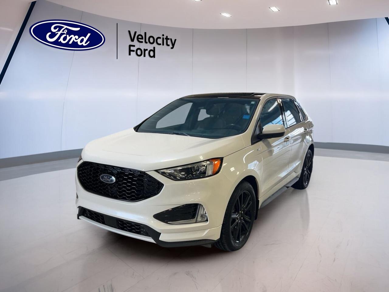 This 2022 Ford Edge ST Line AWD from Velocity Ford in Moose Jaw is a sharp, well-equipped used SUV built for Canadian driving. CARFAX Canada reports no accident, giving you added peace of mind. Finished in White with a Black interior, this four-door model blends sporty style, everyday comfort, and confident all-wheel drive.

With 108,397 km, this 2022 Ford Edge ST Line AWD continues to offer strong value for drivers who want useful technology, practical cargo room, and a smooth automatic transmission. Its 2.0-litre unleaded engine and 8-speed automatic help deliver balanced power for commuting, highway travel, and changing road conditions through the year.

FEATURES OF THE Edge ST Line AWD
»» Sporty ST-Line exterior design details
»» All-wheel drive for added confidence
»» Rear spoiler adds athletic character
»» LED headlamps enhance road visibility

ADVANCED SAFETY FEATURES
»» Backup camera helps with safer reversing
»» Blind spot monitor supports lane awareness
»» Lane departure warning adds extra confidence
»» Side curtain airbags help protect occupants

PERFORMANCE AND EFFICIENCY
»» 2.0-litre engine balances power and efficiency
»» 8-speed automatic supports smooth shifting
»» All-wheel drive improves year-round traction
»» Limited slip differential aids road grip

COMFORT AND CONVENIENCE
»» Heated front seats add winter comfort
»» Dual-zone climate control keeps comfort balanced
»» Remote starter helps in cold mornings
»» Power liftgate simplifies cargo access

TECHNONOLGY AND CONNECTIVITY
»» Bluetooth integration supports hands-free communication
»» WiFi hotspot keeps passengers connected
»» Satellite radio expands entertainment choices
»» Steering wheel audio controls add ease

CARGO SPACE
»» Rear trunk access makes loading simple
»» Power liftgate adds everyday convenience
»» Four-door layout supports family practicality
»» Flexible cargo area suits daily errands

AWARDS & RECOGNITIONS
»» Top Safety Pick, Insurance Institute for Highway Safety, 2022

WHAT OTHER OWNERS LIKE
»» Comfortable ride for daily driving
»» Useful cargo room for active lifestyles
»» Easy-to-use infotainment and connectivity features
»» Confident all-wheel drive in poor weather

The 2022 Ford Edge ST Line AWD offers a smart mix of style and function without overcomplicating your drive. Automatic headlights, fog lights, heated mirrors, power windows, power steering, and push button start all help make daily use feel simple and refined. Tinted windows, ambient lighting, and a leather-wrapped steering wheel also add a more upscale feel inside.

This SUV is also equipped with important everyday safety and driver-assist items, including Anti-Lock Braking System, stability control, tire pressure monitoring, child safety locks, driver and passenger airbags, head side airbags, and a passenger airbag sensor. These features help support peace of mind whether you are driving in town, on the highway, or through changing prairie weather.

Inside, comfort-focused details help make every trip more enjoyable. You get front air conditioning, automatic climate control, drivers seat lumbar support, a power drivers seat, a power passenger seat, illuminated vanity mirrors, rear window defroster, and an auto-dimming rearview mirror. This 2022 Ford Edge ST Line AWD is ready to handle weekday routines and weekend plans with equal ease.

This 2022 Ford Edge ST Line AWDs VIN is: 2FMPK4J99NBA50927 .
