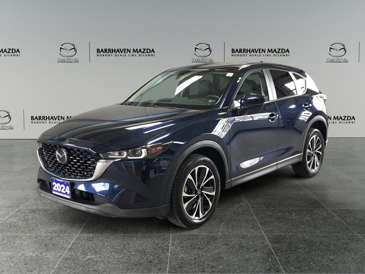 Experience the thrill of the 2024 Mazda CX-5 GS in a stunning Blue finish with its advanced AWD drivetrain. This SUV is built for exceptional handling and versatility, making every drive a pleasure. Step inside and be greeted by a meticulously designed interior where comfort meets style. The alloy wheels add a touch of sophistication to its already impressive exterior. Enjoy the convenience of heated seats, cruise control, and power windows, all designed to enhance your driving experience. The keyless entry and power seats further add to the premium feel. Stay connected and safe with modern technology features such as Bluetooth connection, smart device integration, and a reliable backup camera. Safety is a priority with lane assist and brake assist systems that provide you with peace of mind on every journey. The automatic transmission ensures a smooth and effortless drive, while the air conditioning maintains your comfort regardless of the weather. This Mazda CX-5 is ideal for families seeking a stylish yet practical vehicle, or for adventure seekers ready to explore new horizons. Contact our dealership today for more information and to arrange a test drive. Let us help you take the next step toward owning this remarkable SUV.