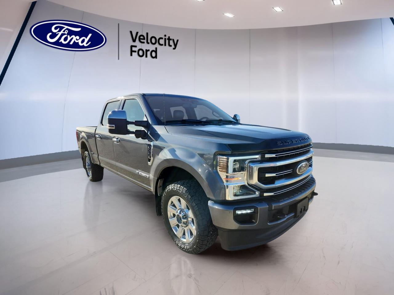Built to handle hard work and long days with ease, this used 2022 Ford Super Duty F-350 SRW Platinum 4WD Crew Cab 6.75 Box COMING SOON is now offered by Velocity Ford in Moose Jaw. It pairs a Grey exterior with a Brown interior, four full doors, and a proven 6.7-litre diesel engine.

With 146,692 km, this truck shows the kind of real-world use expected from a heavy-duty pickup. Its automatic transmission, four-wheel drive system, and 5,533 kg towing capacity make it a strong fit for towing, jobsite duty, and all-season driving across Saskatchewan.

FEATURES OF THE Super Duty F-350 SRW Platinum 4WD Crew Cab 6.75 Box COMING SOON
»» 6.7-litre diesel power for heavy hauling
»» Crew Cab adds roomy passenger space
»» 6.75-foot box supports work gear
»» Four-wheel drive for added traction

ADVANCED SAFETY FEATURES
»» Backup camera helps with tight manoeuvres
»» Blind spot monitor adds driving confidence
»» Side impact airbags help protect occupants
»» Stability control supports secure road handling

TRUCK FEATURES
»» Towing capacity rated at 5,533 kg
»» Limited slip differential aids traction
»» Rear tow hook supports utility tasks
»» Off-road tires add rugged capability

PERFORMANCE AND EFFICIENCY
»» 6.7-litre diesel delivers strong low-end torque
»» Automatic transmission offers smooth power delivery
»» Four-wheel drive supports changing road conditions
»» Power steering helps reduce driver effort

COMFORT AND CONVENIENCE
»» Heated front seats add cold-weather comfort
»» Heated rear seats help keep passengers warm
»» Dual-zone climate control improves cabin comfort
»» Remote starter adds daily convenience

TECHNONOLGY AND CONNECTIVITY
»» Navigation system helps guide every trip
»» Bluetooth integration supports hands-free communication
»» WiFi hotspot keeps devices better connected
»» Steering wheel audio controls simplify access

CARGO SPACE
»» 6.75-foot box supports tools and supplies
»» Rear trunk access helps load smaller items
»» Power retractable running boards ease entry
»» Crew Cab balances cargo and passenger needs

AWARDS & RECOGNITIONS
»» Best Heavy-Duty Truck, The Car Guide, 2022

WHAT OTHER OWNERS LIKE
»» Strong diesel towing power for work
»» Spacious Crew Cab for family travel
»» Comfortable ride for a heavy-duty truck
»» Useful tech features for daily driving

This used 2022 Ford Super Duty F-350 SRW Platinum 4WD Crew Cab 6.75 Box COMING SOON brings together heavy-duty strength, upscale comfort, and practical technology. Features such as heated mirrors, power windows, automatic headlights, fog lights, LED headlamps, tinted windows, push button start, adjustable pedals, and memory settings add everyday ease.

This truck also includes anti-lock braking system, tire pressure monitoring, child safety locks, head side airbags, passenger airbag sensor, auto-dimming rearview mirror, turn signal mirrors, rear window defroster, satellite radio, HD Radio, and a spare tire. It is well equipped for drivers who want confident capability without giving up comfort.

This 2022 Ford Super Duty F-350 SRW Platinum 4WD Crew Cab 6.75 Box COMING SOONs VIN is: 1FT8W3BT0NEE61414.