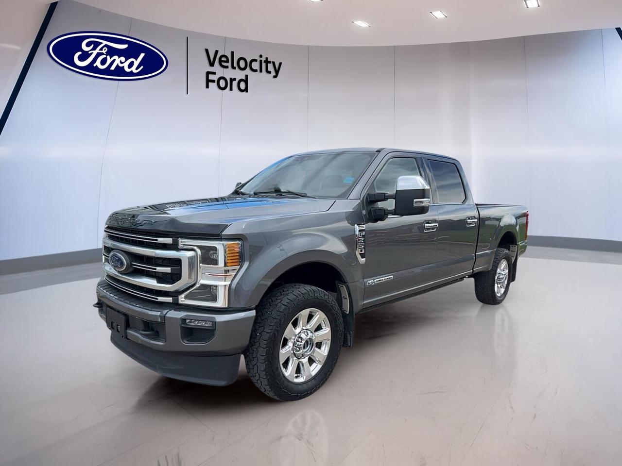 Built to handle hard work and long days with ease, this used 2022 Ford Super Duty F-350 SRW Platinum 4WD Crew Cab 6.75 Box  is now offered by Velocity Ford in Moose Jaw. It pairs a Grey exterior with a Brown interior, four full doors, and a proven 6.7-litre diesel engine.

With 146,705 km, this truck shows the kind of real-world use expected from a heavy-duty pickup. Its automatic transmission, four-wheel drive system, and 5,533 kg towing capacity make it a strong fit for towing, jobsite duty, and all-season driving across Saskatchewan.

FEATURES OF THE Super Duty F-350 SRW Platinum 4WD Crew Cab 6.75 Box 
»» 6.7-litre diesel power for heavy hauling
»» Crew Cab adds roomy passenger space
»» 6.75-foot box supports work gear
»» Four-wheel drive for added traction

ADVANCED SAFETY FEATURES
»» Backup camera helps with tight manoeuvres
»» Blind spot monitor adds driving confidence
»» Side impact airbags help protect occupants
»» Stability control supports secure road handling

TRUCK FEATURES
»» Towing capacity rated at 5,533 kg
»» Limited slip differential aids traction
»» Rear tow hook supports utility tasks
»» Off-road tires add rugged capability

PERFORMANCE AND EFFICIENCY
»» 6.7-litre diesel delivers strong low-end torque
»» Automatic transmission offers smooth power delivery
»» Four-wheel drive supports changing road conditions
»» Power steering helps reduce driver effort

COMFORT AND CONVENIENCE
»» Heated front seats add cold-weather comfort
»» Heated rear seats help keep passengers warm
»» Dual-zone climate control improves cabin comfort
»» Remote starter adds daily convenience

TECHNONOLGY AND CONNECTIVITY
»» Navigation system helps guide every trip
»» Bluetooth integration supports hands-free communication
»» WiFi hotspot keeps devices better connected
»» Steering wheel audio controls simplify access

CARGO SPACE
»» 6.75-foot box supports tools and supplies
»» Rear trunk access helps load smaller items
»» Power retractable running boards ease entry
»» Crew Cab balances cargo and passenger needs

AWARDS & RECOGNITIONS
»» Best Heavy-Duty Truck, The Car Guide, 2022

WHAT OTHER OWNERS LIKE
»» Strong diesel towing power for work
»» Spacious Crew Cab for family travel
»» Comfortable ride for a heavy-duty truck
»» Useful tech features for daily driving

This used 2022 Ford Super Duty F-350 SRW Platinum 4WD Crew Cab 6.75 Boxbrings together heavy-duty strength, upscale comfort, and practical technology. Features such as heated mirrors, power windows, automatic headlights, fog lights, LED headlamps, tinted windows, push button start, adjustable pedals, and memory settings add everyday ease.

This truck also includes anti-lock braking system, tire pressure monitoring, child safety locks, head side airbags, passenger airbag sensor, auto-dimming rearview mirror, turn signal mirrors, rear window defroster, satellite radio, HD Radio, and a spare tire. It is well equipped for drivers who want confident capability without giving up comfort.

This 2022 Ford Super Duty F-350 SRW Platinum 4WD Crew Cab 6.75 Box  VIN is: 1FT8W3BT0NEE61414.