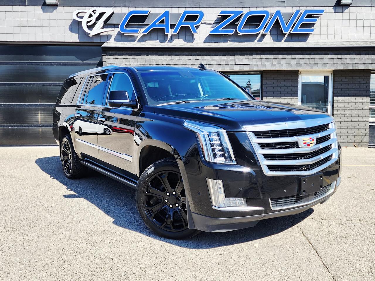 <p>Cruise in ultimate luxury and commanding presence with this stunning 2017 Cadillac Escalade ESV Premium Luxury, now available at Car Zone! This magnificent black beauty offers more than just transportation; it delivers a statement. With its extended wheelbase, youll enjoy a spacious cabin perfect for family adventures or executive travel, ensuring every passenger experiences first-class comfort. This Escalade ESV is the epitome of sophistication and performance, ready to elevate your driving experience to new heights. The odometer reads 187,903 km.</p><p>This Escalade ESV is fully loaded with features designed to impress. Prepare to be wowed by:</p><ul><li><strong>Panoramic Sunroof</strong>: Bask in the sunlight and enjoy breathtaking views with the expansive panoramic sunroof, perfect for those scenic Canadian drives.</li><li><strong>Premium Leather Interior</strong>: Sink into the supple, luxurious leather seats and experience a level of comfort that will make every journey a pleasure.</li><li><strong>Advanced Infotainment System</strong>: Stay connected and entertained with the cutting-edge infotainment system, offering seamless navigation, entertainment, and connectivity features.</li><li><strong>Powerful V8 Engine</strong>: Experience the exhilarating power of the 6.2L V8 engine, providing effortless acceleration and confident handling in any driving situation.</li><li><strong>4-Wheel Drive</strong>: Conquer any road condition with the confidence of 4-wheel drive, ensuring superior traction and control, whether navigating snowy streets or venturing off the beaten path.</li></ul><p>Looking for Your Dream Car? Call or Come on Down to Car Zone Today!</p><p>Thanks for viewing our Car Zone inventory. All of our vehicles come fully detailed with a Carfax and a mechanical fitness assessment. Drive this home today! Easy financing options. All credit welcome.<a href=http://www.carzonecalgary.com/financing/>&nbsp;</a><strong><a href=http://www.carzonecalgary.com/financing/>APPLY NOW</a>&nbsp;</strong>We even take trades. Same day approvals at&nbsp;<a href=http://www.carzonecalgary.com/><strong>CARZONECALGARY</strong></a>&nbsp;or visit us in person at 2036 36 Street SE Calgary for a hassle free test drive. Let our friendly team of experts book an appointment with you and show you the Car Zone difference! AMVIC licensed dealer.&nbsp;</p><p>&nbsp;</p>