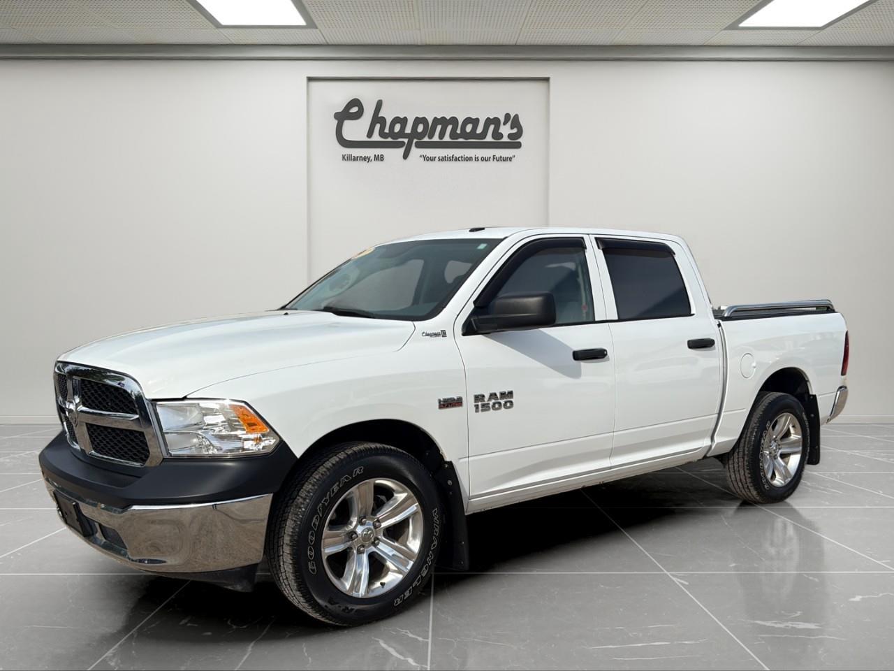 <p>Finished in White with a Grey interior, this 2017 Ram 1500 ST Crew Cab combines HEMI V8 power, 4WD capability, and practical truck versatility in a durable full-size pickup. With its spacious Crew Cab layout and strong towing capability, its built for work, hauling, and everyday driving.</p><p>Powered by a 5.7L HEMI VVT V8 engine with FuelSaver MDS paired to an automatic transmission, this Ram delivers strong performance and dependable towing capability. Equipped with part-time 4WD, trailer sway control, and a heavy-duty cooling system, its ready for tough jobs and changing road conditions.</p><h3>Performance & Capability</h3><ul><li><p>5.7L HEMI VVT V8 engine with FuelSaver MDS</p></li><li><p>Automatic transmission with selectable drive modes</p></li><li><p>4WD with electronic transfer case</p></li><li><p>3.55 rear axle ratio</p></li><li><p>Trailer sway control</p></li><li><p>Trailer wiring harness</p></li><li><p>Heavy-duty transmission oil cooler</p></li><li><p>Engine oil cooler</p></li><li><p>Hill hold control</p></li><li><p>Heavy-duty gas-pressurized shocks</p></li><li><p>Block heater</p></li><li><p>98.4L fuel tank</p></li></ul><h3>Interior Comfort & Convenience</h3><ul><li><p>Spacious Crew Cab configuration</p></li><li><p>Front and rear vinyl seating surfaces</p></li><li><p>Rear folding bench seat</p></li><li><p>Underseat rear storage</p></li><li><p>Cruise control with steering wheel controls</p></li><li><p>Manual air conditioning</p></li><li><p>Driver information centre</p></li><li><p>Full vinyl/rubber floor covering</p></li><li><p>Front centre armrest with cupholders</p></li><li><p>Dual 12V power outlets</p></li></ul><h3>Technology & Connectivity</h3><ul><li><p>Driver information display</p></li><li><p>Electronic throttle control</p></li><li><p>Multiple storage compartments throughout cabin</p></li><li><p>Steering wheel-mounted cruise controls</p></li><li><p>Cargo area concealed storage</p></li></ul><h3>Safety & Driver Assistance</h3><ul><li><p>Electronic stability systems</p></li><li><p>4-wheel ABS disc brakes</p></li><li><p>Tire pressure monitoring system</p></li><li><p>Rear child safety locks</p></li><li><p>Front, side, and curtain airbags</p></li><li><p>Sentry Key immobilizer system</p></li></ul><h3>Exterior Highlights</h3><ul><li><p>White exterior finish</p></li><li><p>17" wheels with hub covers</p></li><li><p>Goodyear all-season tires</p></li><li><p>Black grille and black exterior trim</p></li><li><p>Black front and rear bumpers</p></li><li><p>Deep tinted glass</p></li><li><p>Cargo lamp with high-mounted stop light</p></li><li><p>Automatic halogen headlights</p></li><li><p>Full-size spare tire</p></li></ul><p>A dependable full-size truck that combines legendary HEMI V8 performance, practical Crew Cab space, and 4WD capability for work and everyday driving.</p><p>Price Includes Dealer Fee.</p><p>Price Excludes PST & GST.</p><p>Financing Options Available, Call For More Details.</p> <p><strong>*While every reasonable effort is made to ensure the accuracy of this information, we are not responsible for any error or omissions contained on these pages. Please verify any information in question with Chapman Motors Ltd.</strong></p>