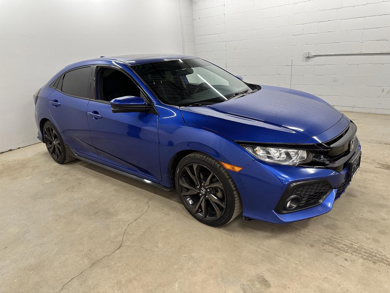 <p>Looking for a sporty and engaging drive that doesnt compromise on style or practicality? Troys Toys is excited to present this fantastic used 2017 Honda Civic Sport. Dressed in a striking blue exterior and featuring a sleek black interior, this Civic is ready to turn heads wherever you go. Under the hood, the efficient 1.5L I4 engine paired with a crisp manual transmission promises an exhilarating driving experience that puts you firmly in control. Whether youre navigating city streets or enjoying a weekend cruise, this front-wheel-drive sedan offers a perfect blend of responsiveness and everyday usability.</p><p>This 2017 Honda Civic Sport has seen its share of adventures, with 164,778 kilometers on the odometer, a testament to its enduring Honda reliability. Its a well-equipped vehicle thats been cherished and is now ready for its next owner to enjoy its many benefits. The 4-door sedan body style makes it incredibly versatile, perfect for commuters, small families, or anyone who appreciates a well-engineered and fun-to-drive automobile.</p><p>Here are five features that make this 2017 Honda Civic Sport truly stand out:</p><ul><li><strong>Sport Trim:</strong> Experience a more dynamic feel with the dedicated Sport trim, designed for those who crave a bit more excitement behind the wheel.</li><li><strong>Manual Transmission:</strong> Feel the road and enjoy every shift with the engaging and classic manual gearbox &ndash; perfect for true driving enthusiasts.</li><li><strong>1.5L I4 Engine:</strong> Benefit from a potent yet fuel-efficient engine that delivers spirited performance for your daily drives and beyond.</li><li><strong>Striking Blue Exterior:</strong> Make a statement with this eye-catching blue paint, offering a vibrant and stylish presence on the road.</li><li><strong>Sleek Black Interior:</strong> Step into a sophisticated cabin with a clean and modern black interior that complements the cars sporty demeanor.</li></ul><p><strong><em>Powered by AutoIntelligence&trade;</em></strong></p><p>Vehicle information has been generated using artificial intelligence and is provided for informational purposes only. While efforts are made to ensure accuracy, please confirm all details directly with the dealer.</p>