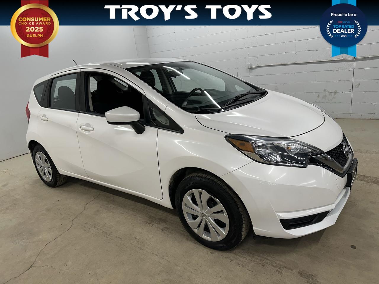 <p>Looking for a reliable and economical ride to navigate the streets of Canada? Troys Toys is excited to present this pre-loved 2019 Nissan Versa Note S, a fantastic option for anyone seeking practicality and ease of driving. Finished in a crisp white exterior and featuring a comfortable black interior, this Versa Note S has been driven a solid 134,067 kilometers and is ready for its next adventure. Its versatile hatchback design makes it incredibly adaptable, whether youre running errands in the city, heading out for a weekend getaway, or simply need ample cargo space for your gear.</p><p>Under the hood, youll find a fuel-efficient 1.6-liter four-cylinder engine paired with a smooth Continuously Variable Transmission (CVT). This combination is designed to offer a comfortable and responsive driving experience while keeping your fuel costs down. The front-wheel drive ensures confident handling in various Canadian weather conditions, making it a sensible choice year-round. This 2019 Nissan Versa Note S is more than just a car; its a practical partner for your daily life.</p><p>Here are five features of this 2019 Nissan Versa Note S that we think youll love:</p><ul><li><strong>Hatchback Versatility:</strong> Effortlessly load groceries, sports equipment, or luggage with the flexible rear hatch, offering surprising cargo capacity for its compact size.</li><li><strong>Fuel-Efficient 1.6L Engine:</strong> Enjoy savings at the pump with this peppy yet economical engine, perfect for both city commuting and longer journeys.</li><li><strong>Smooth CVT Transmission:</strong> Experience a seamless and relaxed drive thanks to the Continuously Variable Transmission, designed for optimal performance and comfort.</li><li><strong>Front-Wheel Drive Confidence:</strong> Navigate through varying road conditions with the dependable traction and handling provided by the front-wheel drive system.</li><li><strong>Practical 4-Door Design:</strong> Easy access for all passengers and convenient loading make this 4-door hatchback a truly user-friendly vehicle.</li></ul><p><strong><em>Powered by AutoIntelligence&trade;</em></strong></p><p>Vehicle information has been generated using artificial intelligence and is provided for informational purposes only. While efforts are made to ensure accuracy, please confirm all details directly with the dealer.</p>