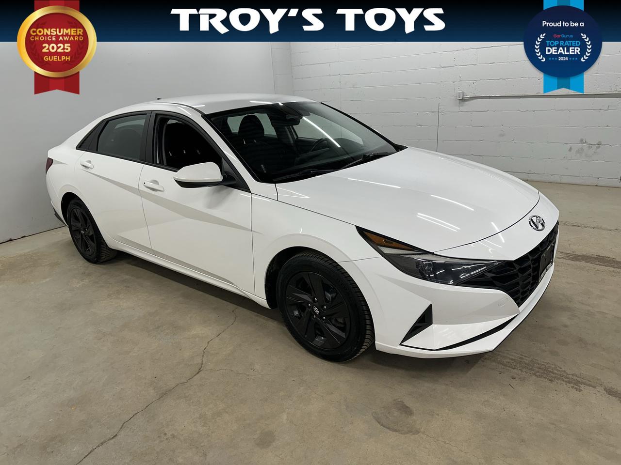 <p>Get ready to experience the perfect blend of style, efficiency, and modern convenience with this fantastic used 2021 Hyundai Elantra Preferred IVT, available now at Troys Toys! This sharp white sedan, with its sleek black interior, is designed to impress. Under the hood, youll find a responsive 2.0L I4 engine paired with a smooth Variable/CVT transmission, delivering an economical yet engaging driving experience. Perfect for navigating city streets or cruising on the highway, this front-wheel-drive Elantra offers everything you need for your daily commute and weekend adventures.</p><p>With 154,255 kilometers on the odometer, this Elantra has been well-travelled and is ready for many more miles of reliable service. Whether youre a first-time car buyer, looking for a fuel-efficient daily driver, or simply seeking a dependable and stylish sedan, this 2021 Hyundai Elantra Preferred IVT at Troys Toys is an excellent choice. Come on down and see for yourself why the Elantra remains a favourite!</p><p>Here are 5 sizzling features of this 2021 Hyundai Elantra Preferred IVT:</p><ul><li><strong>Fuel-Efficient 2.0L Engine:</strong> Cruise past the pumps with impressive gas mileage, saving you money on every journey.</li><li><strong>Smooth & Responsive IVT Transmission:</strong> Experience seamless acceleration and a comfortable ride thanks to this advanced continuously variable transmission.</li><li><strong>Sleek Exterior Design:</strong> Turn heads with the Elantras modern, eye-catching lines and crisp white paint.</li><li><strong>Comfortable Black Interior:</strong> Sink into a refined and spacious cabin, designed for driver and passenger comfort on every drive.</li><li><strong>Dependable Front-Wheel Drive:</strong> Enjoy confident handling and efficient performance, ideal for Canadian road conditions.</li></ul><p><strong><em>Powered by AutoIntelligence&trade;</em></strong></p><p>Vehicle information has been generated using artificial intelligence and is provided for informational purposes only. While efforts are made to ensure accuracy, please confirm all details directly with the dealer.</p>