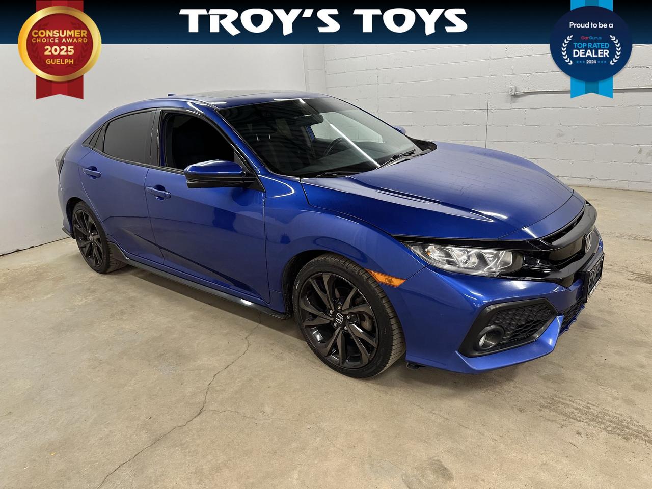<p>Looking for a sporty and engaging drive that doesnt compromise on style or practicality? Troys Toys is excited to present this fantastic used 2017 Honda Civic Sport. Dressed in a striking blue exterior and featuring a sleek black interior, this Civic is ready to turn heads wherever you go. Under the hood, the efficient 1.5L I4 engine paired with a crisp manual transmission promises an exhilarating driving experience that puts you firmly in control. Whether youre navigating city streets or enjoying a weekend cruise, this front-wheel-drive sedan offers a perfect blend of responsiveness and everyday usability.</p><p>This 2017 Honda Civic Sport has seen its share of adventures, with 164,778 kilometers on the odometer, a testament to its enduring Honda reliability. Its a well-equipped vehicle thats been cherished and is now ready for its next owner to enjoy its many benefits. The 4-door sedan body style makes it incredibly versatile, perfect for commuters, small families, or anyone who appreciates a well-engineered and fun-to-drive automobile.</p><p>Here are five features that make this 2017 Honda Civic Sport truly stand out:</p><ul><li><strong>Sport Trim:</strong> Experience a more dynamic feel with the dedicated Sport trim, designed for those who crave a bit more excitement behind the wheel.</li><li><strong>Manual Transmission:</strong> Feel the road and enjoy every shift with the engaging and classic manual gearbox &ndash; perfect for true driving enthusiasts.</li><li><strong>1.5L I4 Engine:</strong> Benefit from a potent yet fuel-efficient engine that delivers spirited performance for your daily drives and beyond.</li><li><strong>Striking Blue Exterior:</strong> Make a statement with this eye-catching blue paint, offering a vibrant and stylish presence on the road.</li><li><strong>Sleek Black Interior:</strong> Step into a sophisticated cabin with a clean and modern black interior that complements the cars sporty demeanor.</li></ul><p><strong><em>Powered by AutoIntelligence&trade;</em></strong></p><p>Vehicle information has been generated using artificial intelligence and is provided for informational purposes only. While efforts are made to ensure accuracy, please confirm all details directly with the dealer.</p>