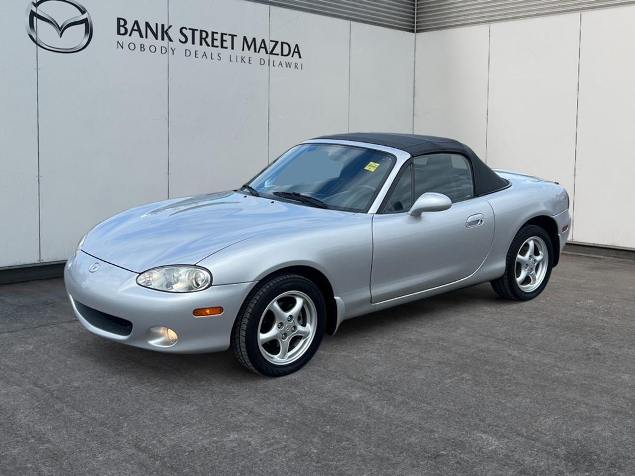 Experience the timeless charm of the 2002 Mazda MX-5 Miata, a stunning convertible in a classic hue thats perfect for exhilarating drives. With its Rear-Wheel Drive (RWD) and Automatic transmission, this convertible offers an effortless yet engaging driving experience, ensuring you stay connected to the road. The MX-5 Miata boasts stylish alloy wheels that complement its athletic stance, enhancing both its appearance and performance. Inside, youll find a comfortable and well-appointed cabin equipped with power windows, providing convenience at your fingertips. This Mazda is designed with thoughtful technology and driver-focused features that cater to your on-the-road needs. Whether youre cruising along the coastline or navigating city streets, you can do so with confidence and peace of mind. If youre an enthusiast seeking a fun driving experience or someone who appreciates classic convertible design, the 2002 Mazda MX-5 Miata is the ideal choice. Contact our dealership today to learn more and arrange a test drive.