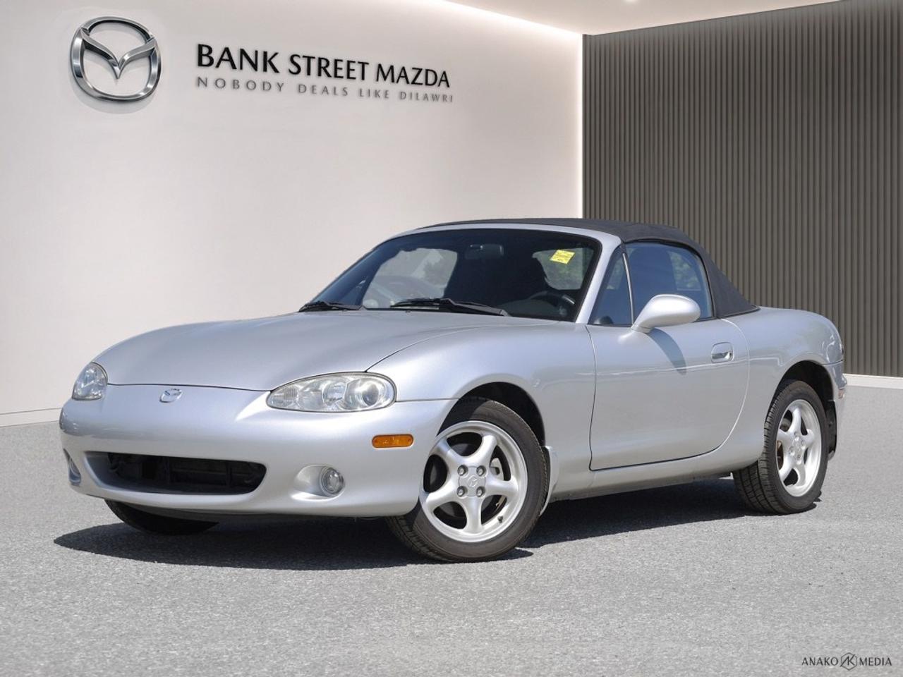 - Inc. 2 Year / 40,000 KM Powertrain WarrantyExperience the timeless charm of the 2002 Mazda MX-5 Miata, a stunning convertible in a classic hue thats perfect for exhilarating drives. With its Rear-Wheel Drive (RWD) and Automatic transmission, this convertible offers an effortless yet engaging driving experience, ensuring you stay connected to the road. The MX-5 Miata boasts stylish alloy wheels that complement its athletic stance, enhancing both its appearance and performance. Inside, youll find a comfortable and well-appointed cabin equipped with power windows, providing convenience at your fingertips. This Mazda is designed with thoughtful technology and driver-focused features that cater to your on-the-road needs. Whether youre cruising along the coastline or navigating city streets, you can do so with confidence and peace of mind. If youre an enthusiast seeking a fun driving experience or someone who appreciates classic convertible design, the 2002 Mazda MX-5 Miata is the ideal choice. Contact our dealership today to learn more and arrange a test drive.