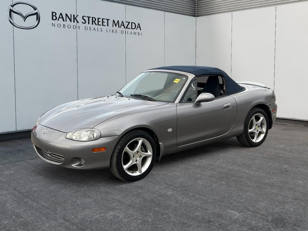 - Inc. 2 Year / 40,000 KM Powertrain WarrantyThe 2003 Mazda MX-5 Miata is a captivating ride with its classic Convertible design and a manual transmission paired with a rear-wheel-drive system to ensure the utmost enjoyment in handling. Its charming appearance is further enhanced by stylish alloy wheels, giving it a striking profile on the road. Inside, the MX-5 Miata welcomes you with a driver-focused cockpit that offers power windows for added convenience. The intuitive layout ensures a simple yet fulfilling driving experience that enthusiasts will appreciate. This Mazda emphasizes the joy of driving with features prioritized for the open-road adventurer and spirited driving experiences. While safety in this classic convertible focuses on basics, the driving experience is about connection and control more than ever, blending technology perfectly with tradition. If youre a driving enthusiast or a lover of classic convertibles looking for an engaging ride, the 2003 Mazda MX-5 Miata is perfect for you. We invite you to contact the dealership today for more details on making this timeless roadster yours.