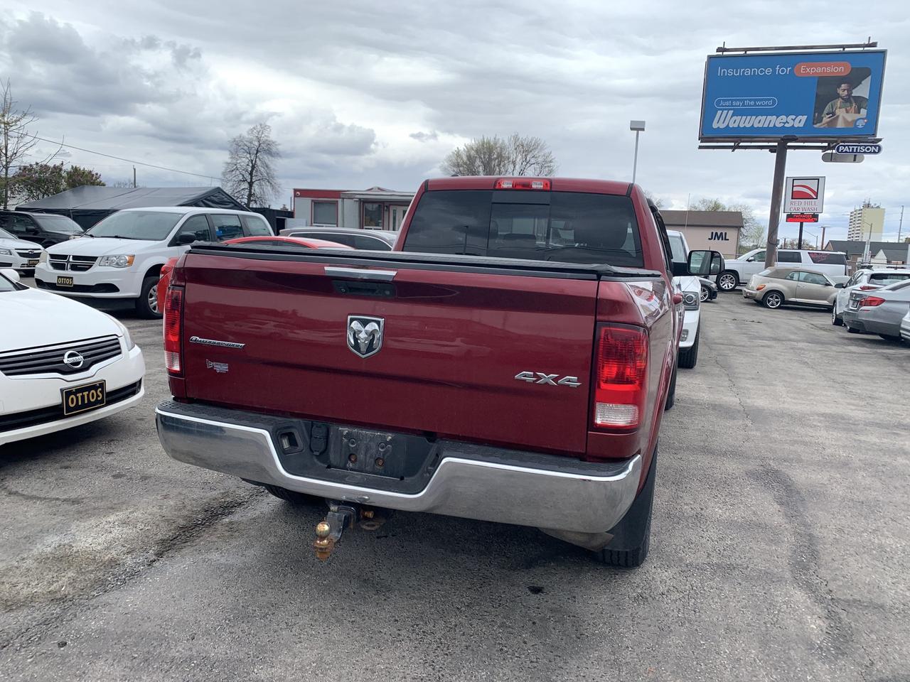 2014 RAM 1500 4WD Quad Cab 140.5  Outdoorsman Photo