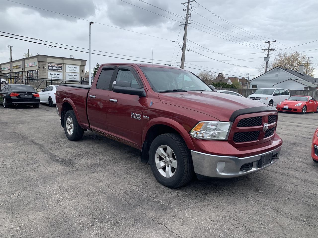 2014 RAM 1500 4WD Quad Cab 140.5  Outdoorsman Photo