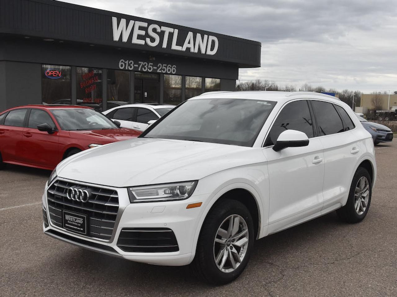 <p>Experience the perfect blend of sophistication and capability with this stunning pre-owned 2019 Audi Q5 Komfort 45 TFSI quattro, proudly offered at Westland Auto Sales. Dressed in a classic white exterior and featuring a warm brown interior, this SUV crossover exudes understated luxury. Under the hood, youll find a potent yet efficient 2.0L 4-cylinder engine paired with an automatic transmission and Audis legendary quattro all-wheel drive system, ensuring confident handling in any Canadian weather. With only 89,724 kilometers on the odometer, this Q5 is ready for your next adventure.</p><p>This 2019 Audi Q5 Komfort is designed for those who appreciate refined engineering and everyday practicality. Its versatile SUV/Crossover body style offers ample space for passengers and cargo, making it ideal for everything from daily commutes to weekend getaways. The combination of gasoline power and advanced all-wheel drive provides a driving experience that is both engaging and secure. Whether youre navigating city streets or exploring scenic routes, this Audi Q5 promises a premium experience.</p><p>Here are five of the standout features that make this 2019 Audi Q5 Komfort truly exceptional:</p><ul><li><strong>Legendary quattro All-Wheel Drive:</strong> Conquer any road condition with Audis renowned quattro system, providing unparalleled traction and stability for a truly confident drive.</li><li><strong>Smooth and Responsive Automatic Transmission:</strong> Effortlessly glide through gears with the precise and intuitive automatic transmission, delivering seamless power delivery.</li><li><strong>Luxurious Brown Interior:</strong> Step into an inviting and sophisticated cabin finished in a rich brown interior, adding a touch of warmth and elegance to every journey.</li><li><strong>Powerful and Efficient 2.0L TFSI Engine:</strong> Experience exhilarating performance and impressive fuel economy thanks to the turbocharged 2.0-litre TFSI engine.</li><li><strong>Versatile SUV/Crossover Practicality:</strong> Enjoy the perfect balance of elevated driving position, spaciousness for all your needs, and the refined handling of a premium sedan.</li></ul><p><strong><em>Powered by AutoIntelligence&trade;</em></strong></p><p>Vehicle information has been generated using artificial intelligence and is provided for informational purposes only. While efforts are made to ensure accuracy, please confirm all details directly with the dealer.</p>