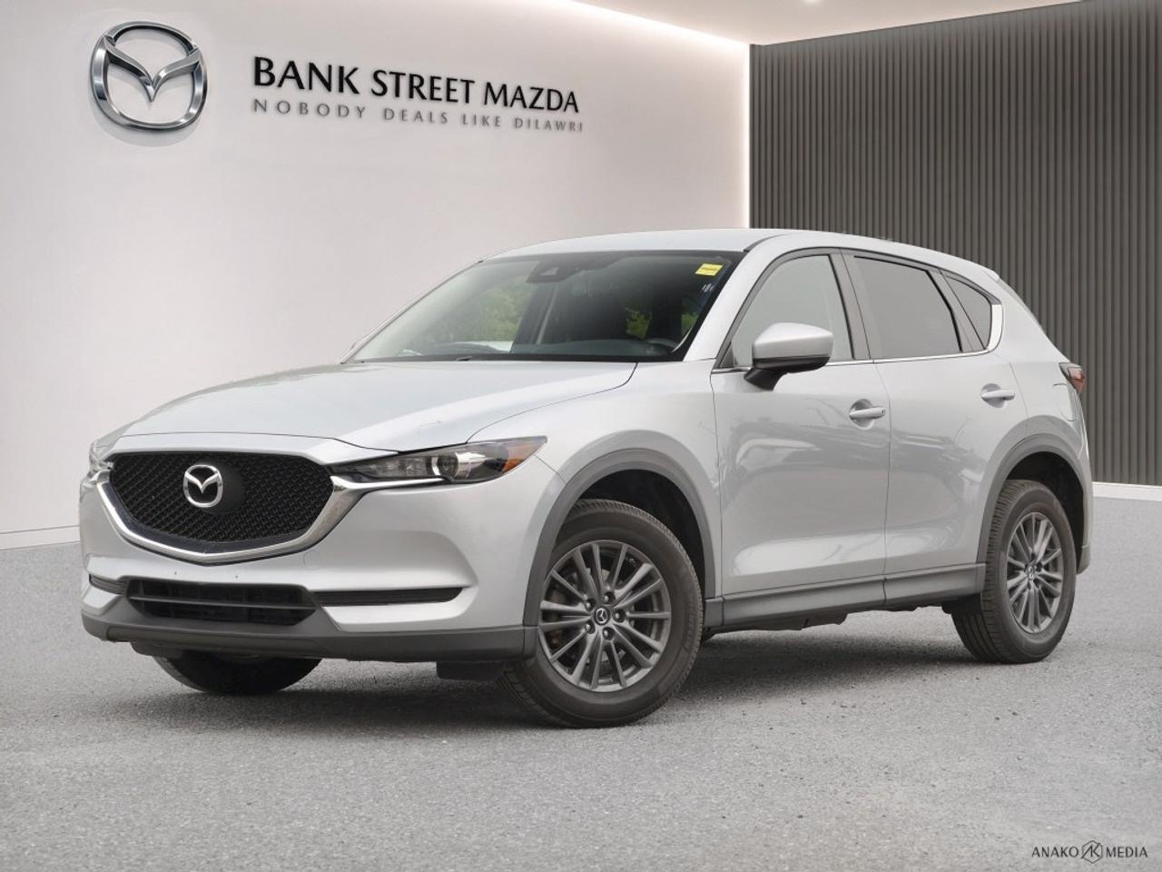 The 2019 Mazda CX-5 GX in sophisticated hues offers a smooth driving experience with its front-wheel drive (FWD) drivetrain and responsive handling. This SUVs exterior is accentuated by stylish alloy wheels, giving it a confident stance that is complemented by a sleek body design. Inside, youll appreciate the practicality and comfort with features like heated seats and power windows, making every drive enjoyable. The interior promises a touch of luxury while maintaining functional convenience. Stay connected and secure with advanced technology features such as a backup camera and smart device integration. Safety is prioritized with features like lane assist and brake assist, part of a suite of driver assistance technologies that enhance your journeys. Additionally, the Mazda CX-5 includes a Bluetooth connection for seamless integration of your devices and keyless entry for hassle-free access. This vehicle is perfect for those who value both style and substance, offering an excellent blend of technology and functionality. Whether you are commuting in the city or venturing out on a family trip, the 2019 Mazda CX-5 GX Auto FWD is equipped to elevate your driving experience. Contact the dealership today for more details and let this remarkable SUV make your everyday travels extraordinary.