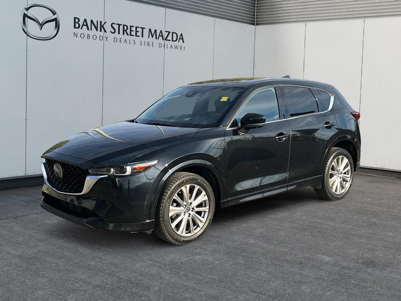 The 2022 Mazda CX-5 Signature AWD stands out in a striking black exterior paired with an automatic transmission and advanced AWD drivetrain, offering you reliable handling and performance on Canadian roads. The sleek SUV body type complements the luxurious details such as alloy wheels and a smart sunroof/moonroof, ensuring you have both style and functionality in your ride. Step inside to experience the premium leather seats and elegant leatherette door trims, all designed to provide a sophisticated and comfortable driving environment. Technological advancements make every ride a pleasure with features like a heads-up display, Bluetooth connection, and smart device integration. The state-of-the-art navigation system ensures you always find the best route, while advanced safety features like lane assist, parking sensors, and adaptive cruise control enhance your peace of mind on every trip. Ideal for those who demand both luxury and innovation in their daily drives, this Mazda CX-5 Signature AWD with its family-friendly features like heated and cooled seats promises comfort on every journey. Dont miss your chance to own this versatile SUVcontact the dealership today to learn more and schedule a test drive!