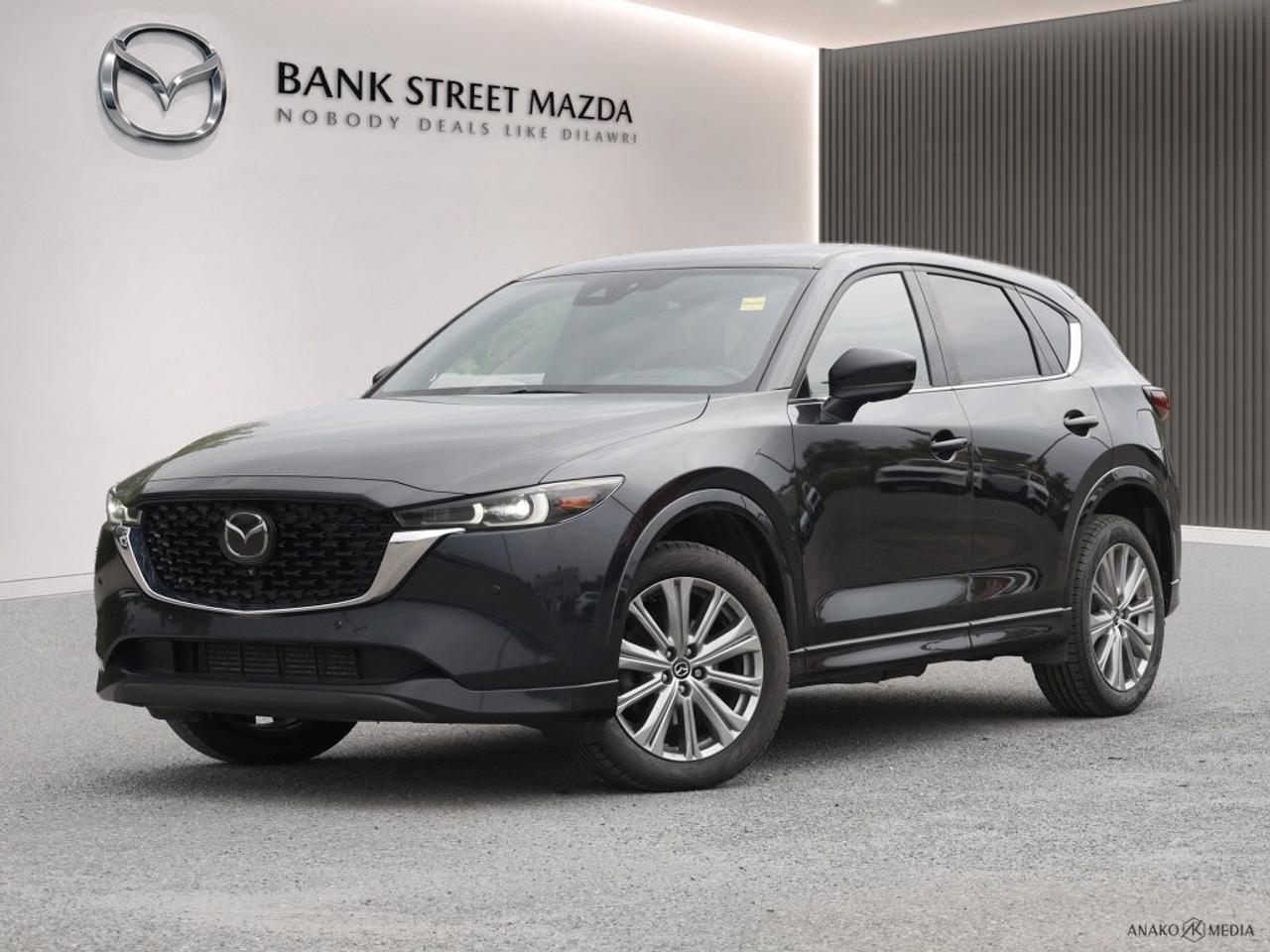 The 2022 Mazda CX-5 Signature AWD stands out in a striking black exterior paired with an automatic transmission and advanced AWD drivetrain, offering you reliable handling and performance on Canadian roads. The sleek SUV body type complements the luxurious details such as alloy wheels and a smart sunroof/moonroof, ensuring you have both style and functionality in your ride. Step inside to experience the premium leather seats and elegant leatherette door trims, all designed to provide a sophisticated and comfortable driving environment. Technological advancements make every ride a pleasure with features like a heads-up display, Bluetooth connection, and smart device integration. The state-of-the-art navigation system ensures you always find the best route, while advanced safety features like lane assist, parking sensors, and adaptive cruise control enhance your peace of mind on every trip. Ideal for those who demand both luxury and innovation in their daily drives, this Mazda CX-5 Signature AWD with its family-friendly features like heated and cooled seats promises comfort on every journey. Dont miss your chance to own this versatile SUVcontact the dealership today to learn more and schedule a test drive!