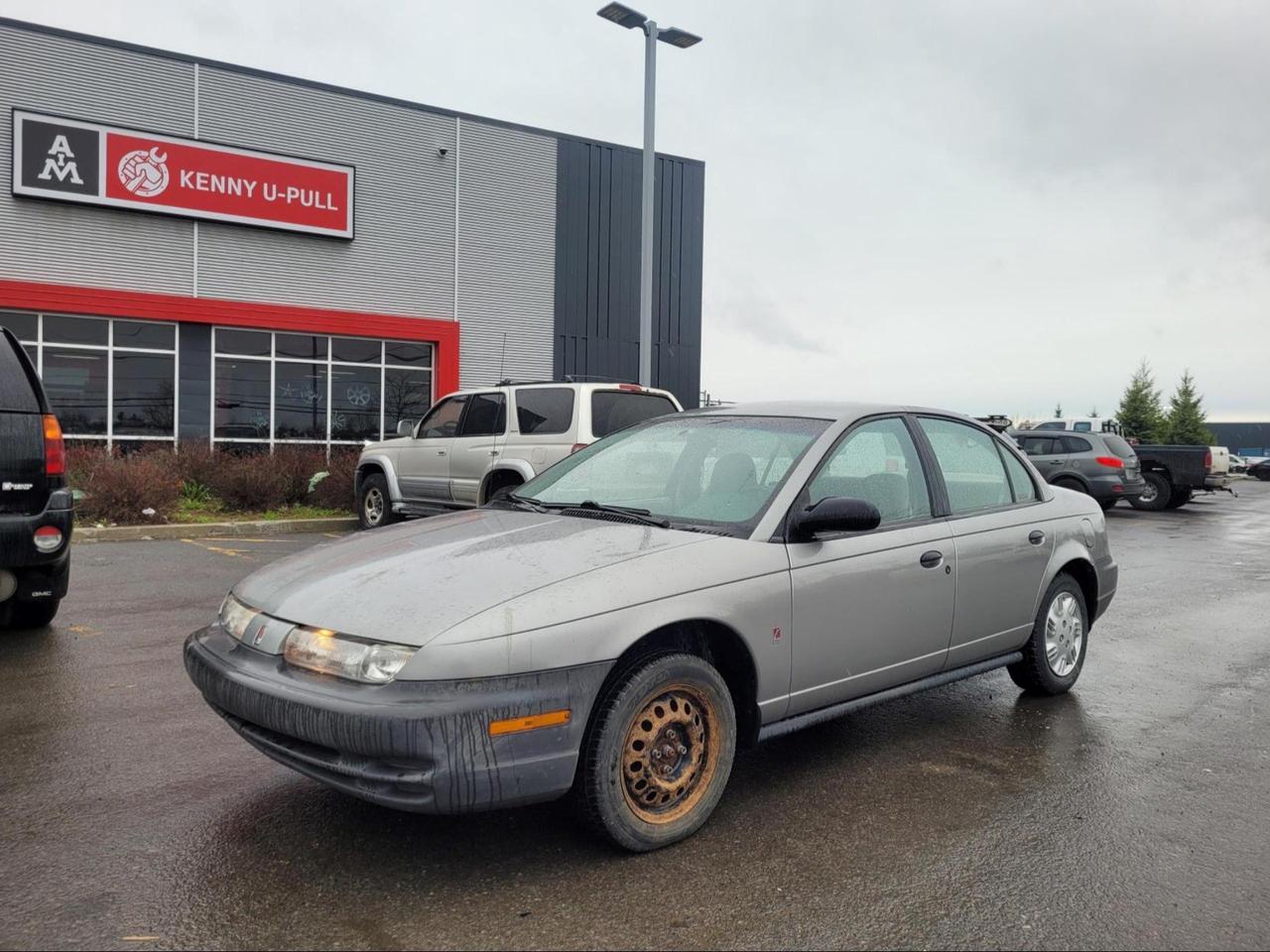 1997 Saturn SL in Silver. The vehicle has 100,935km. The vehicle runs and drives. The brake lights are on and needs a brake job. Has a slight misfire. Exhaust leak. Some rust spots around the vehicle. We dont perform any mechanical/safety inspections. The vehicle is sold as is and might need some work.