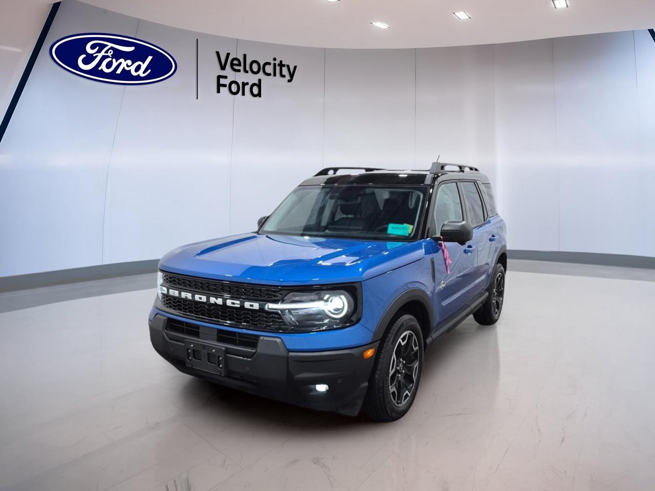 Meet the 2025 Ford Bronco Sport Outer Banks 4x4, a used SUV now at Velocity Ford in Moose Jaw. Finished in Blue with a Blue interior, this four-door model blends everyday comfort with confident utility. With only 7,492 km, automatic transmission, and a 1.5-litre unleaded engine, it is ready for work, travel, and weekend escapes.

This 2025 Ford Bronco Sport Outer Banks 4x4 gives you the sure-footed feel of four-wheel drive and the ease of a compact SUV. It is well equipped with practical features drivers want most, including heated front seats, remote starter, dual-zone climate control, and a backup camera for simple daily use in all seasons.

FEATURES OF THE Bronco Sport Outer Banks 4x4
»» Blue exterior with four-door SUV practicality
»» Automatic transmission with four-wheel drive capability
»» Heated front seats for cold mornings
»» Remote starter adds year-round daily comfort

ADVANCED SAFETY FEATURES
»» Anti-lock braking system helps controlled stops
»» Stability control supports confident road handling
»» Backup camera aids reversing and parking
»» Blind spot monitor boosts lane awareness

PERFORMANCE AND EFFICIENCY
»» 1.5-litre unleaded engine balances daily efficiency
»» Eight-speed automatic supports smooth acceleration
»» Four-wheel drive adds all-season traction
»» Cruise control helps relaxed highway driving

COMFORT AND CONVENIENCE
»» Dual-zone climate control keeps comfort balanced
»» Heated front seats warm winter commutes
»» Power windows simplify everyday operation
»» Push button start adds easy access

TECHNOLOGY AND CONNECTIVITY
»» Bluetooth integration supports hands-free calling
»» Satellite radio expands listening choices
»» Steering wheel audio controls reduce distraction
»» Automatic headlights respond to changing light

CARGO SPACE
»» Rear trunk access makes loading easier
»» Four-door design improves passenger entry
»» Flexible cabin suits daily cargo needs
»» SUV layout supports active lifestyles

AWARDS & RECOGNITIONS
»» Top Safety Pick, Insurance Institute for Highway Safety, 2024

WHAT OTHER OWNERS LIKE
»» Easy-to-drive size for city parking
»» Useful cargo room for daily errands
»» Heated seats improve cold-weather comfort
»» Confident all-wheel capability in poor weather

This Bronco Sport is equipped with many sought-after details that make a difference every day. You will find power steering, heated mirrors, electric mirrors, memory mirrors, tinted windows, fog lights, LED headlamps, tire pressure monitoring, lane departure warning, child safety locks, head side airbags, side impact airbags, driver airbag, passenger airbag, passenger airbag sensor, and automatic door locks.

Inside, this Bronco Sport also adds front air conditioning, automatic climate control, an auto-dimming rearview mirror, illuminated driver and passenger vanity mirrors, drivers seat lumbar support, drivers side power seat, electric passenger seat, memory seats, and an adjustable steering wheel. It is a smart choice for drivers who want comfort, safety, and lasting Ford utility in one well-rounded package.

This 2025 Ford Bronco Sport Outer Banks 4x4s VIN is: 3FMCR9CN1SRF42592.