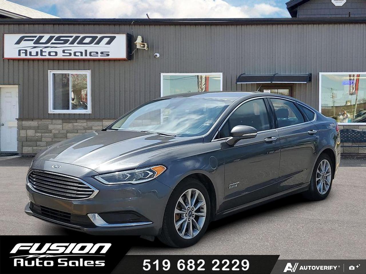 <p>Discover a smart and stylish way to drive with this pre-owned 2018 Ford Fusion Energi SE, now available at Fusion Auto Sales. This sophisticated gray sedan offers the efficiency of a hybrid powertrain without compromising on performance, making it an ideal choice for your daily commute and beyond. Step inside to a comfortable black interior, designed for a refined driving experience.</p><p>Under the hood, youll find a 2.0L V4 engine paired with a smooth Variable/CVT transmission, delivering an efficient ride with front-wheel drive for confident handling. With 153,079 kilometers on the odometer, this Fusion Energi SE has been well-maintained and is ready for its next adventure with you behind the wheel. Experience the blend of technology, comfort, and eco-conscious driving that this 2018 Ford Fusion Energi SE has to offer.</p><p>Here are five features with the most sizzle:</p><ul><li><strong>Plug-in Hybrid Capability:</strong> Enjoy the flexibility of electric-only driving for shorter trips and the seamless transition to gasoline power for longer journeys, significantly reducing your fuel costs.</li><li><strong>SE Trim Enhancements:</strong> This SE trim level brings a touch of refinement and desirable features to your driving experience, making every trip more enjoyable.</li><li><strong>Spacious Sedan Comfort:</strong> The 4-door sedan body style provides ample space for passengers and cargo, ensuring practicality for families and everyday needs.</li><li><strong>Efficient 2.0L V4 Hybrid Engine:</strong> Experience a harmonious balance of power and remarkable fuel economy, designed to save you money at the pump.</li><li><strong>Sleek Exterior and Interior Design:</strong> The eye-catching gray exterior is complemented by a stylish black interior, offering a modern and sophisticated aesthetic thats sure to turn heads.</li></ul><p><strong><em>Powered by AutoIntelligence&trade;</em></strong></p><p>Vehicle information has been generated using artificial intelligence and is provided for informational purposes only. While efforts are made to ensure accuracy, please confirm all details directly with the dealer.</p><p>The Fusion Philosophy<br><br>At Fusion Auto Sales, we put more effort into buying our vehicles than we do trying to sell them. By constantly monitoring what other car lots are doing, we strive to be the lowest priced dealer in our market. We won&rsquo;t purchase a vehicle to &ldquo;fill a hole&rdquo;. We know that the vehicles on our lot are great value for the money and smart shoppers realize that also. Adhering to this philosophy makes it easy for our customers. If they find a vehicle on our lot that fulfills their needs and wants, they know that they&rsquo;re getting great value. <br><br>If we don&rsquo;t have what you&rsquo;re looking for, we can find it! Over 150 customers have saved thousands of dollars buy joining our&rdquo; locate club&rdquo;. People that know what they want and what they want to pay (within reason of course), get the vehicle of their dreams and enjoy huge savings. Contact us for details.<br><br><br><br>Fusion Auto Sales is in Tilbury, Ont. located between Windsor and London right off the 401. We are among 7 dealerships within a &frac12; kilometer distance which is great for out of town shoppers. We began satisfying customers in 2009 and have been doing so ever since. In 2012 Fusion was recognized as 1 of the 50 fastest growing companies in Canada. And then, in 2018, we were named one of the top 5 independent automobile dealerships in the country. <br><br>We specialize in late model vehicles at below than average pricing, everything is fully certified and every unit is Car Proof verified and is fully disclosed with every unit. We offer every type of financing from perfect credit at great rates to credit challenges with competitive rates. We also specialize in locating vehicles for customers, we cant have everything on the lot so if you do not see it and are having a hard time finding what you are looking for, let us know and we can find it for you. Fusion Auto Sales spans its customer base from Windsor all the way to Timmins, On and every where in between. Our philosophy is You are going to like the way we deal and everyone does, straight honest answers with no monkey business and no back and forth between sales and managers.</p>