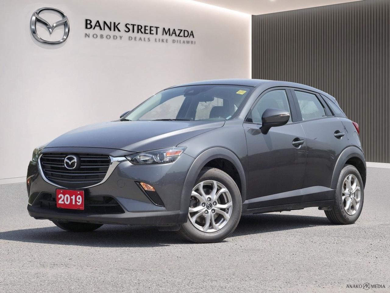 The 2019 Mazda CX-3 GS, elegantly dressed in a refined gray, brings sophistication to all-wheel-drive performance with its commendable handling, making it a perfect companion for various driving conditions. The exterior boasts strikingly designed alloy wheels that complement its SUV body type. The interior invites you in with heated front seats, ensuring comfort regardless of the weather, whilst the leatherette instrument panel and leather/metal-look gear shifter add a touch of class. Not to be left behind in tech, the CX-3 integrates smart devices effortlessly, providing a seamless connection through Bluetooth. The vehicle further exemplifies modern innovation with its backup camera and essential safety features such as lane assist and brake assist, aimed at providing peace of mind on every journey. The heated mirrors and steering wheel, alongside convenient features like keyless entry and power windows, enhance the driving experience, assuring ease and accessibility. Whether youre a tech-savvy individual seeking connectivity or a comfort-oriented driver appreciating ergonomic features, the Mazda CX-3 GS accommodates your needs perfectly. It beckons you to indulge in its comprehensive suite of attributes by reaching out to us for more details. Contact the dealership today to explore this incredible vehicle!