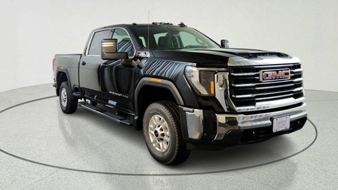 The 2026 GMC Sierra 2500HD SLE is a well-equipped heavy-duty pickup that balances work-ready capability with upgraded comfort and technology, featuring a bold exterior design, multiple cab and bed configurations, and a more refined interior than the base trim. It comes standard with a large 13.4-inch infotainment touchscreen, a 12.3-inch digital driver display, keyless entry with push-button start, and features like a Bose audio system, advanced trailering tech, teh MultiPro tailgate and teh X31 offroad package. Powered by a standard 6.6-liter V8 gas engine it delivers strong towing performance along with essential safety features such as automatic emergency braking and lane-departure warning